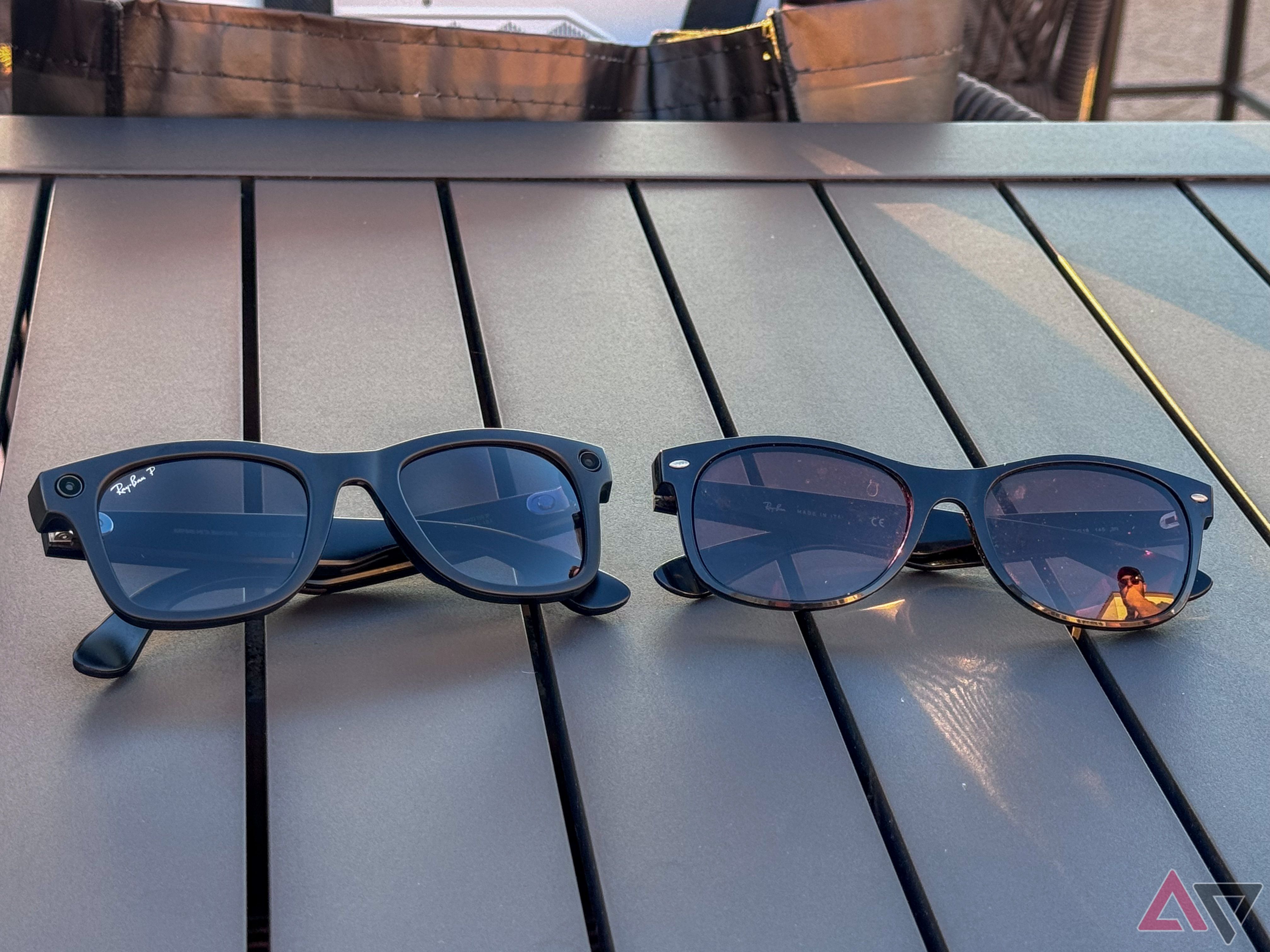 Two pairs of folded sunglasses sitting on a table