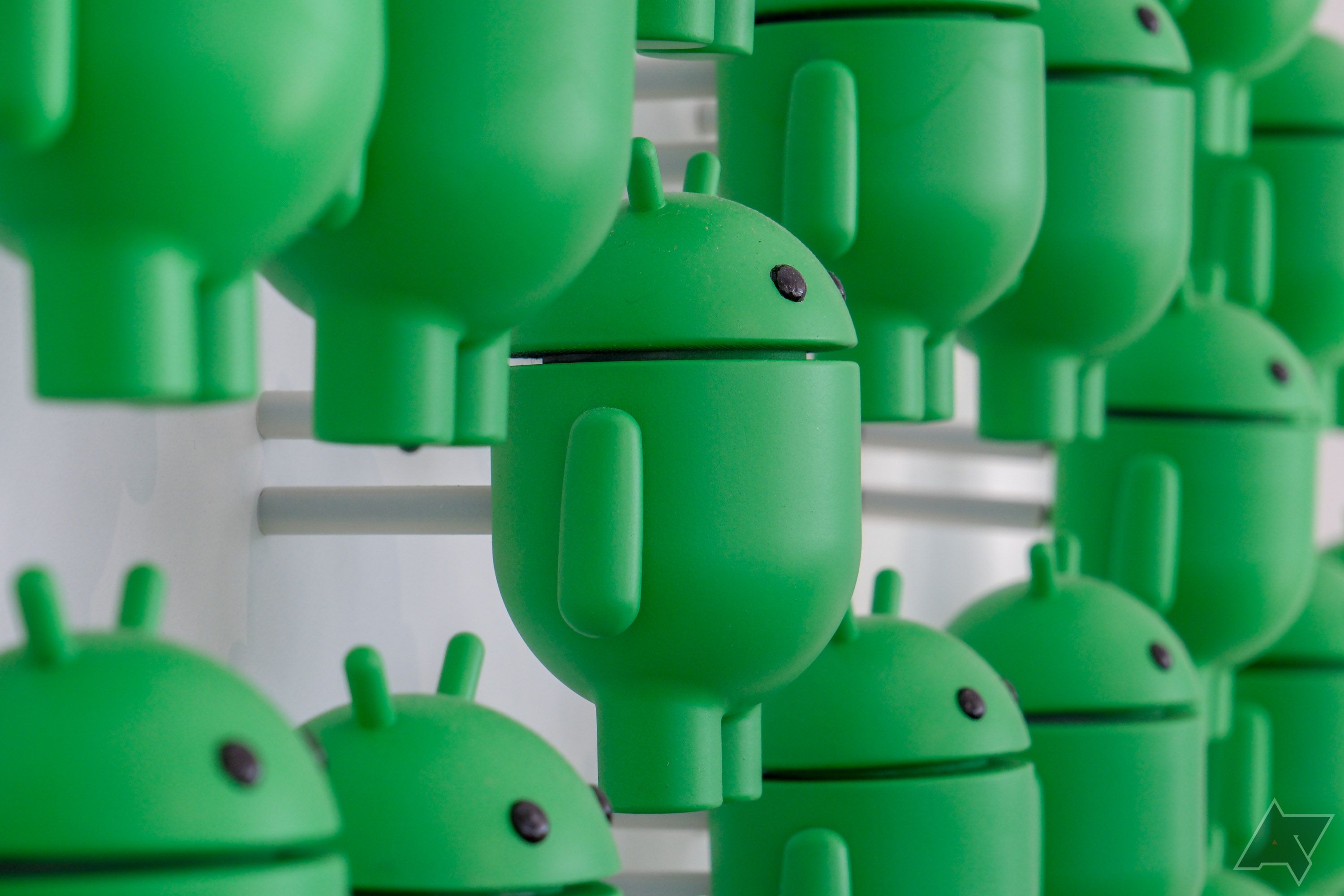 Several green Android mascots attached to a wall