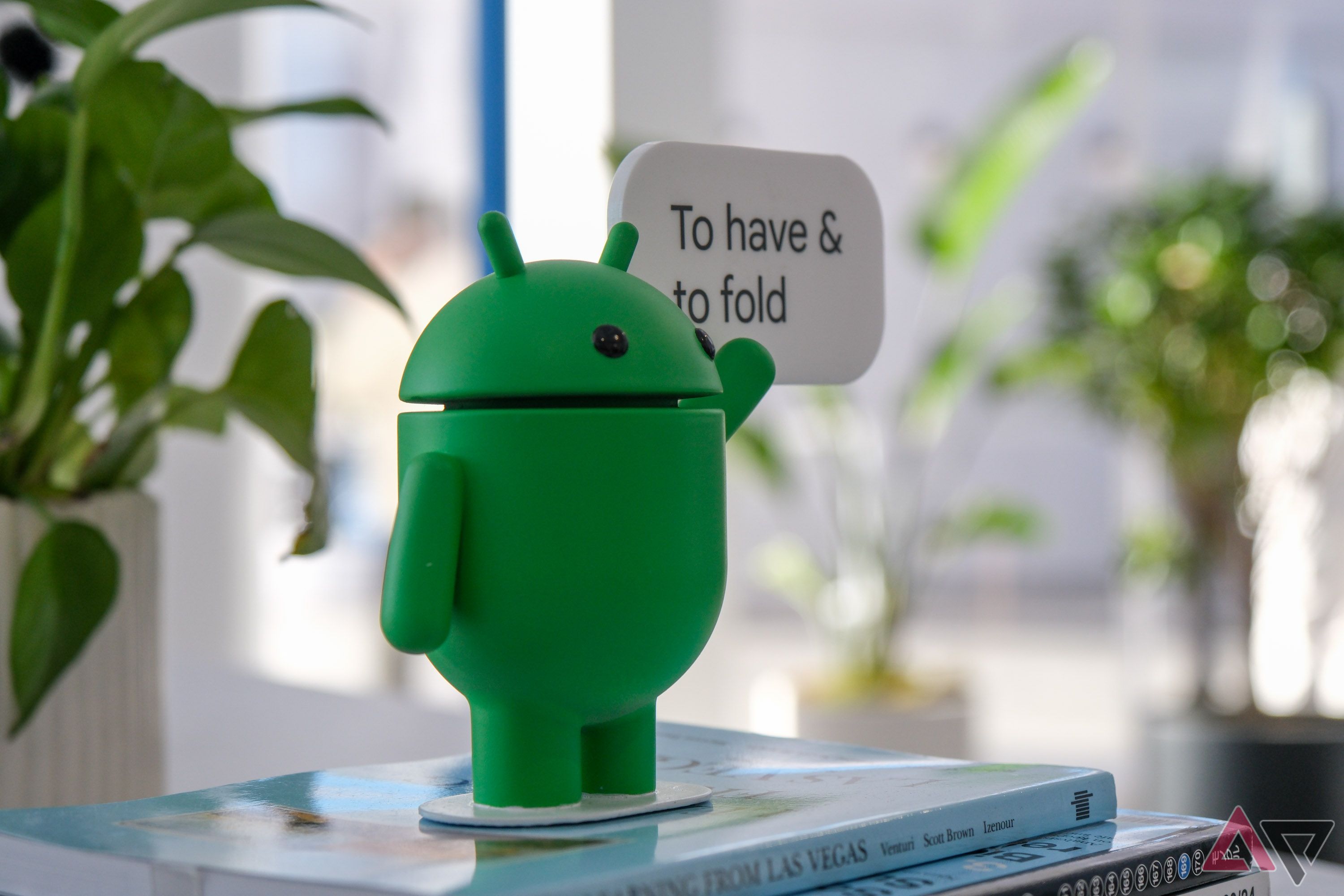 An Android mascot with a sign that says 'To have & to fold'