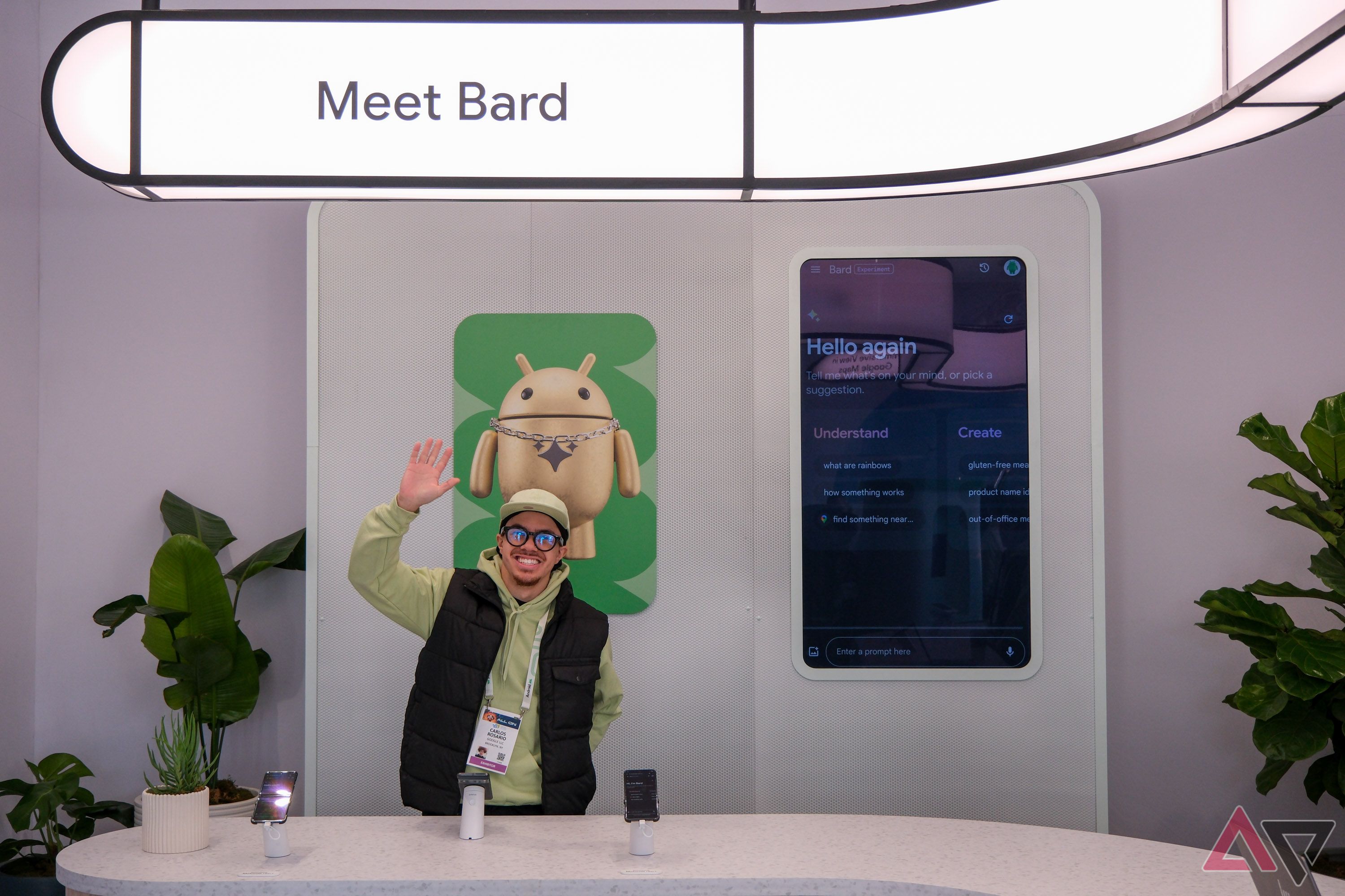 A person smiling and waving under a sign reading 'Meet Bard'