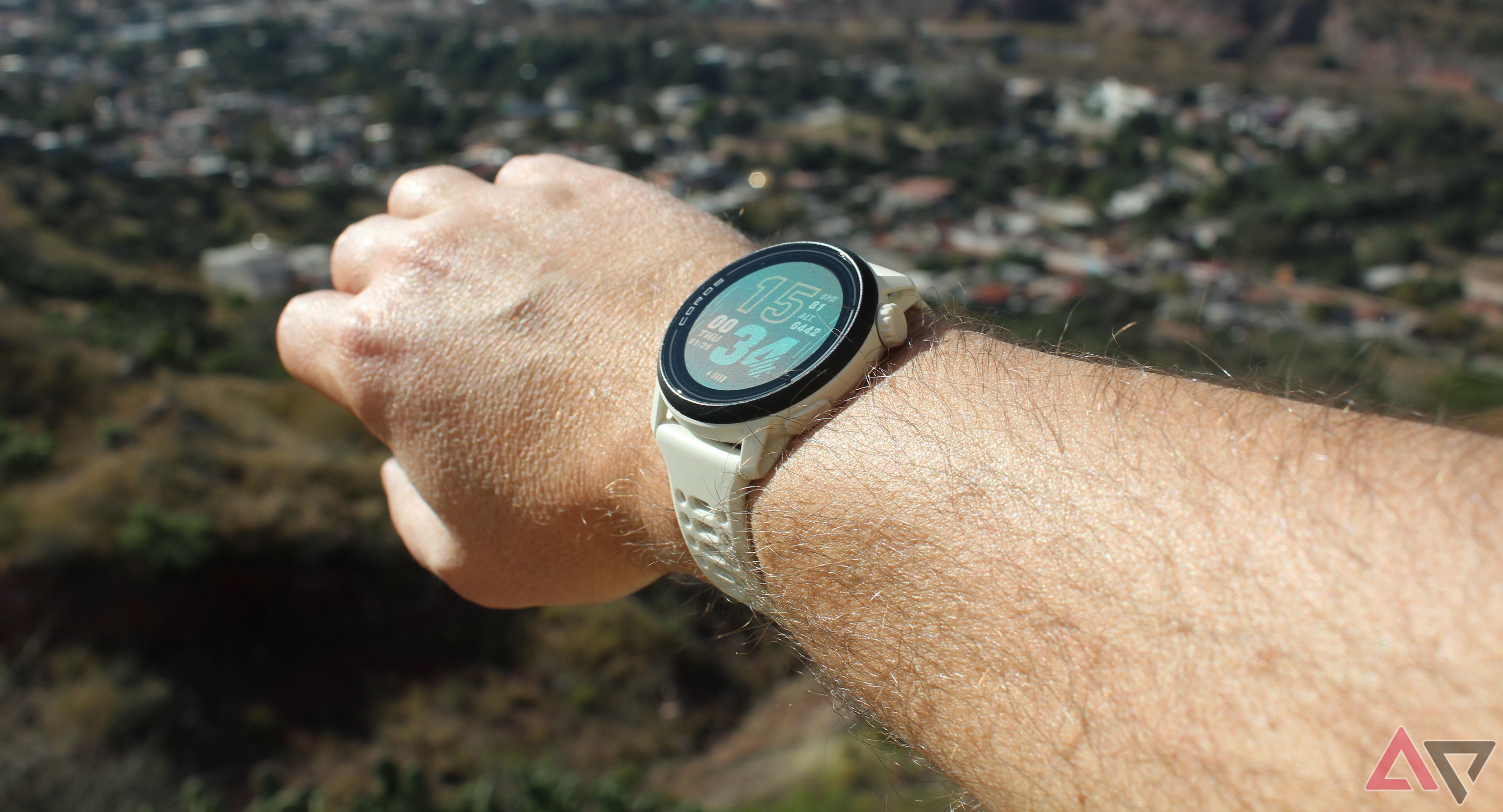 Coros Pace 3 on wrist over the valley
