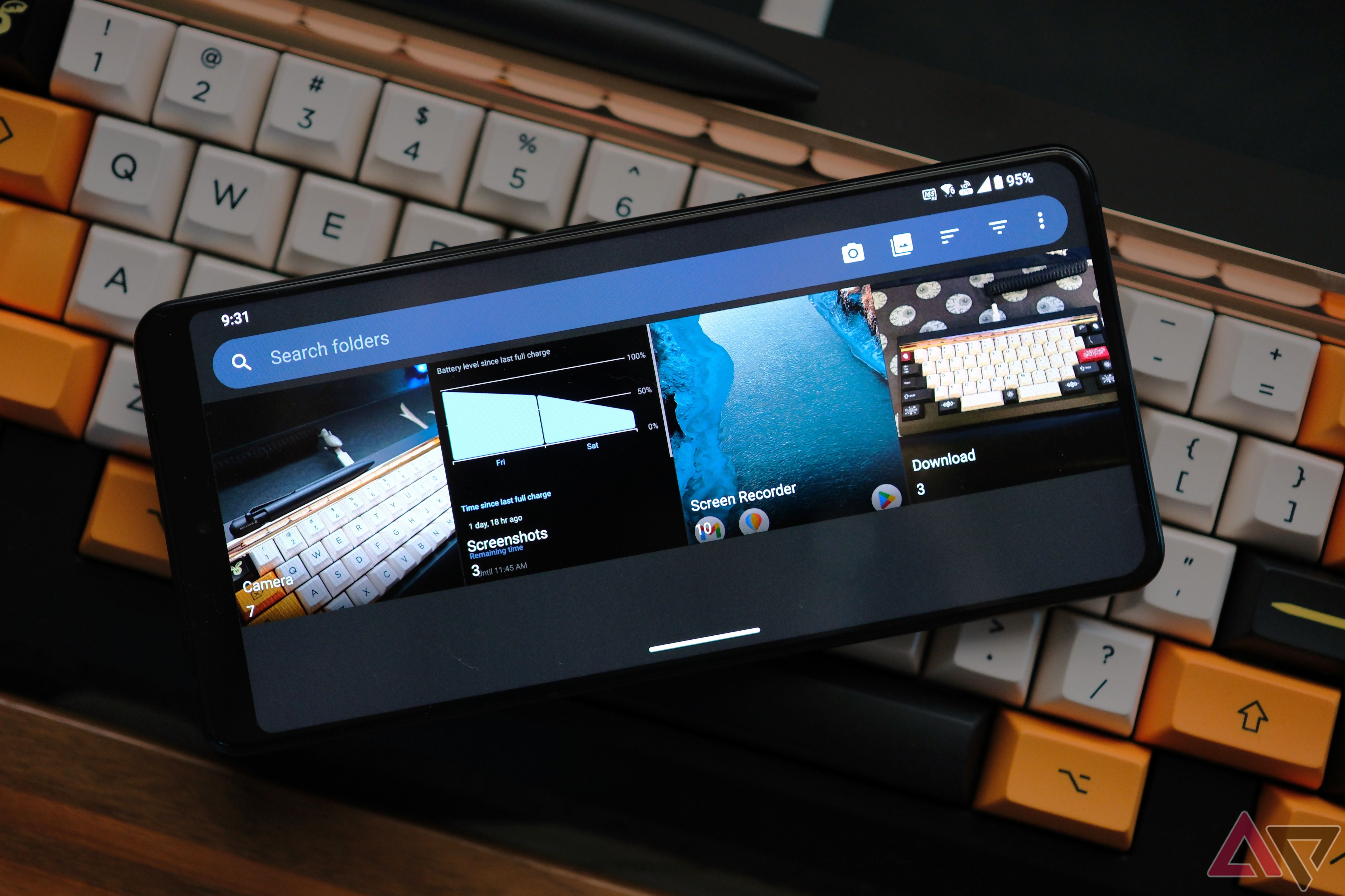 Rog Phone 8 Pro laying on keyboard with Fossify Gallery on the screen