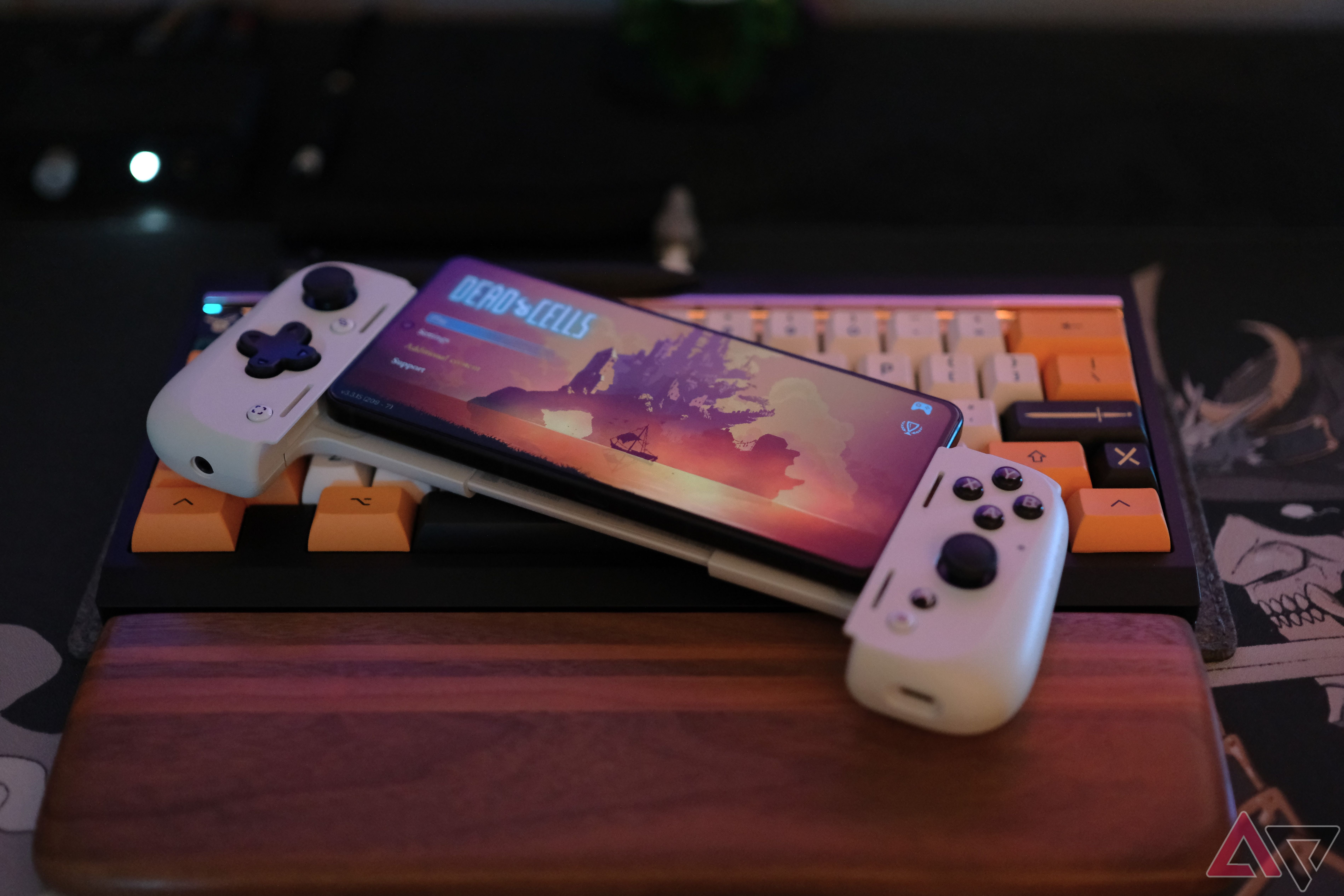 ROG Phone 8 Pro laying on keyboard with kishi controller attatched