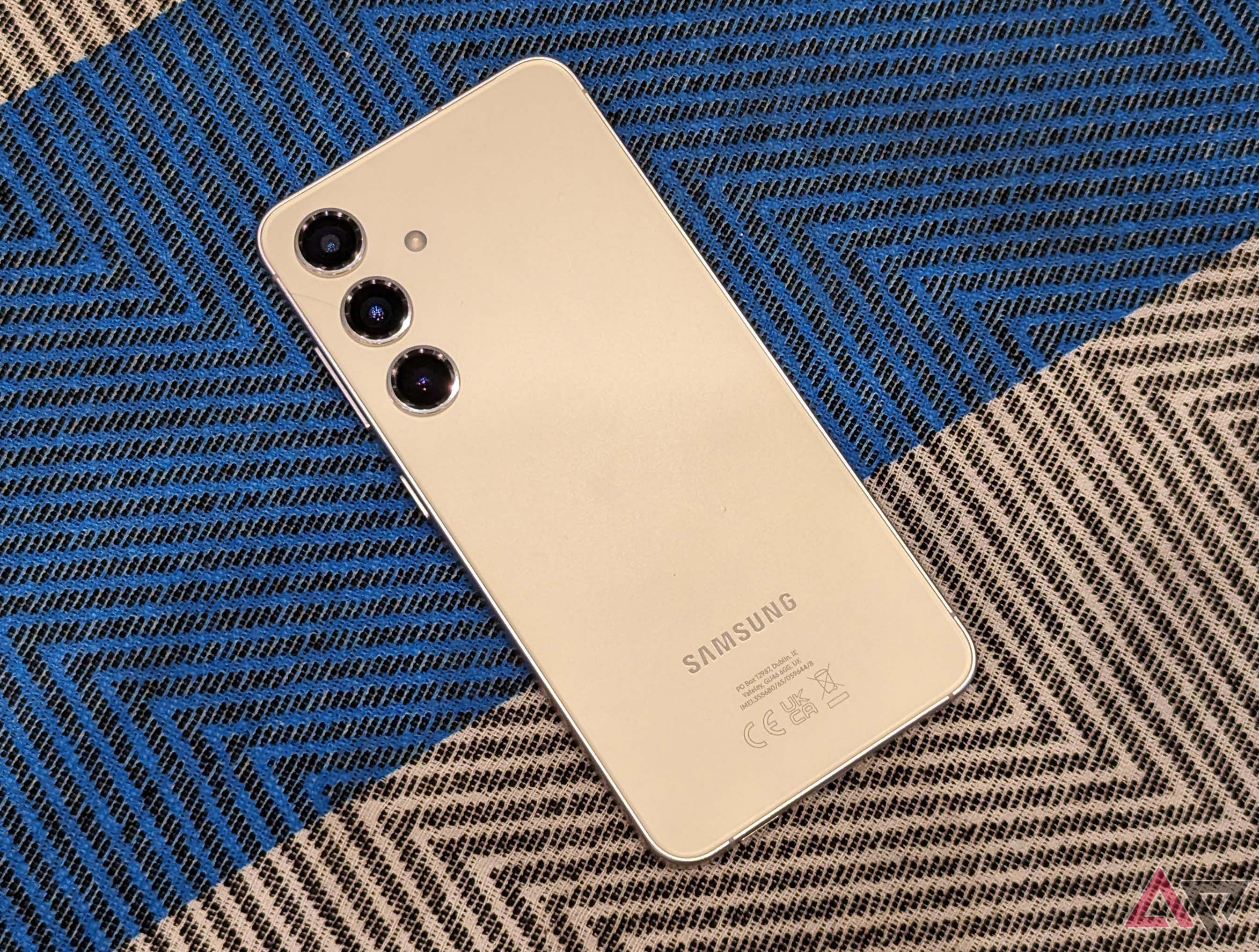 The rear of the Samsung Galaxy S24 on a patterned background
