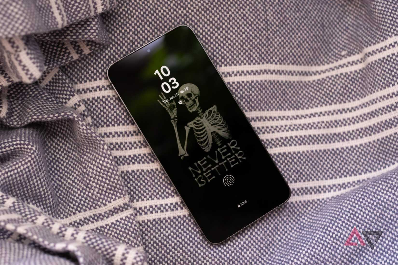 The Samsung Galaxy S24+ on a blanket, with its always-on display showing