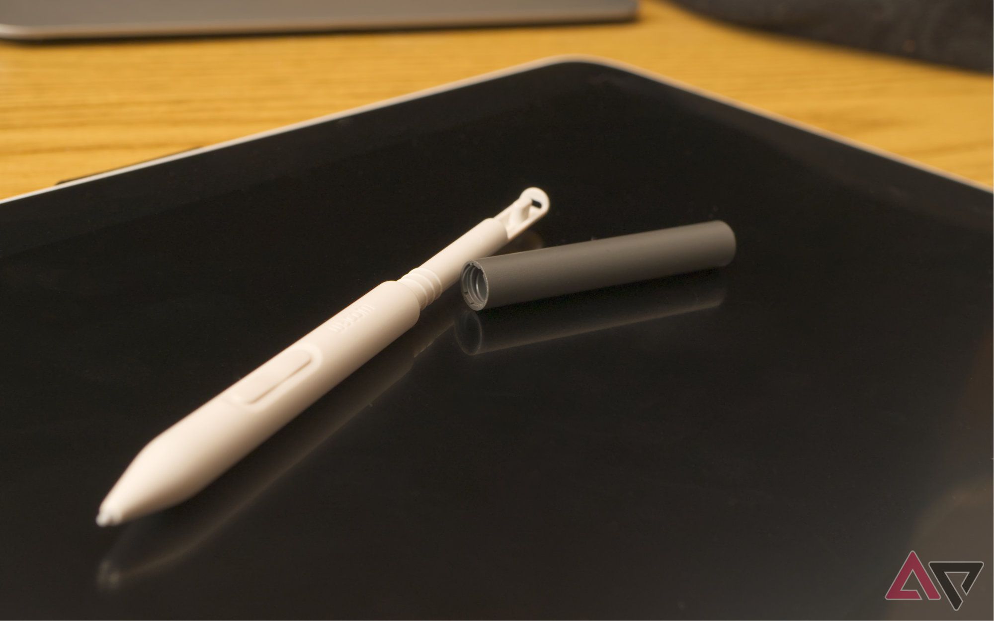 Wacom Stylus unscrewed, set on top of a drawing tablet