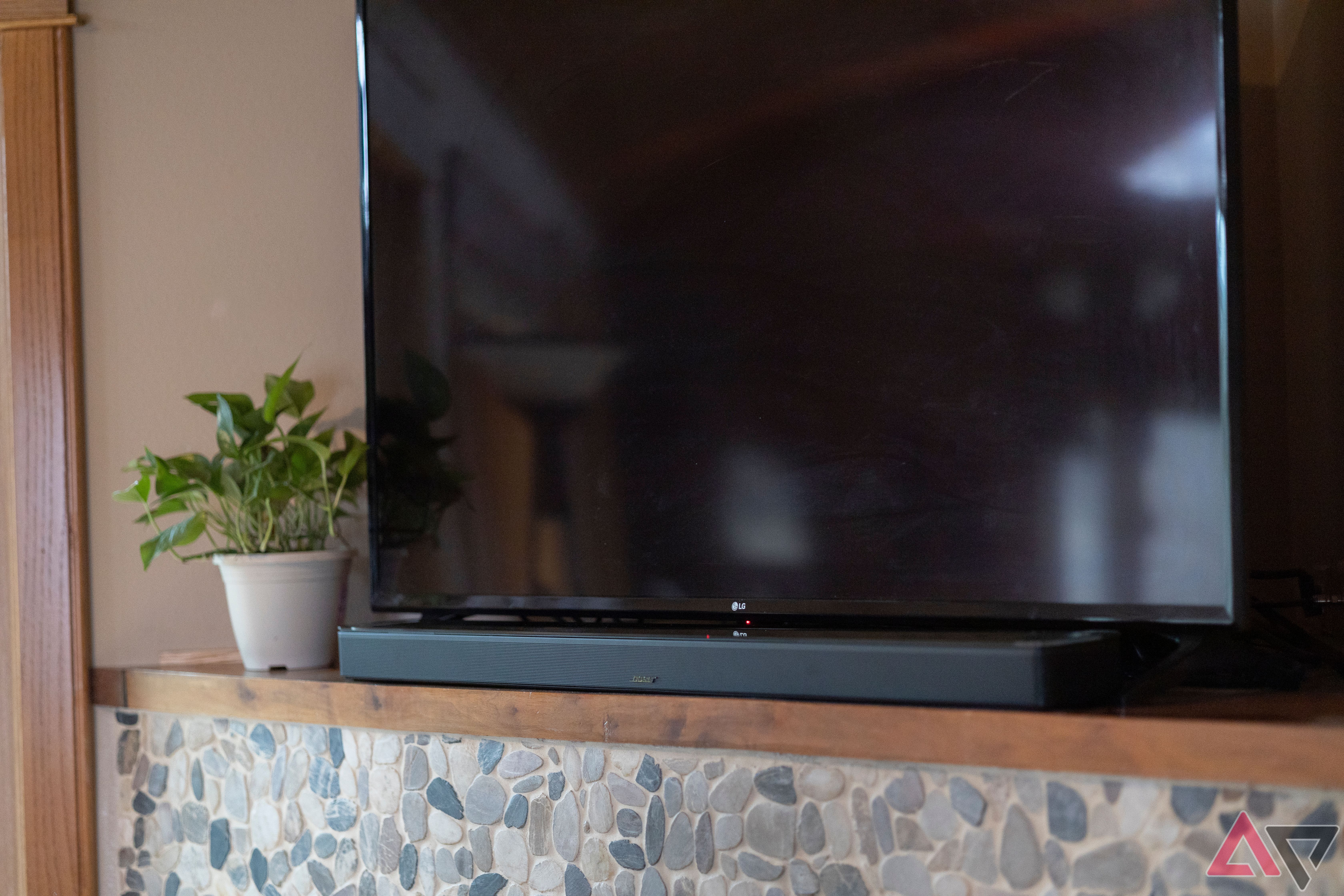 Bose Smart Ultra Soundbar on mantle next to plant and TV
