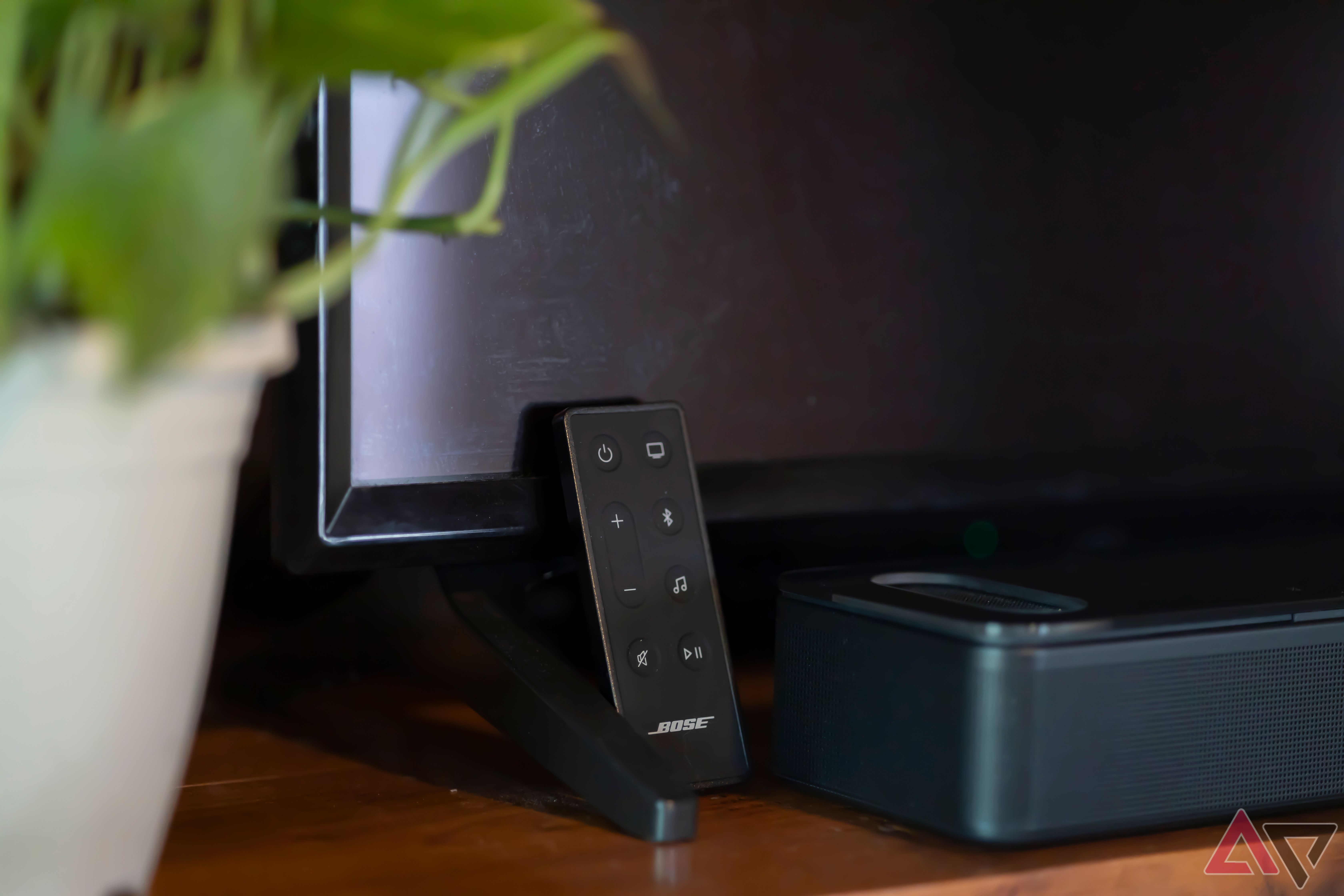 Bose Smart Ultra Soundbar Remote Control next to soundbar and TV