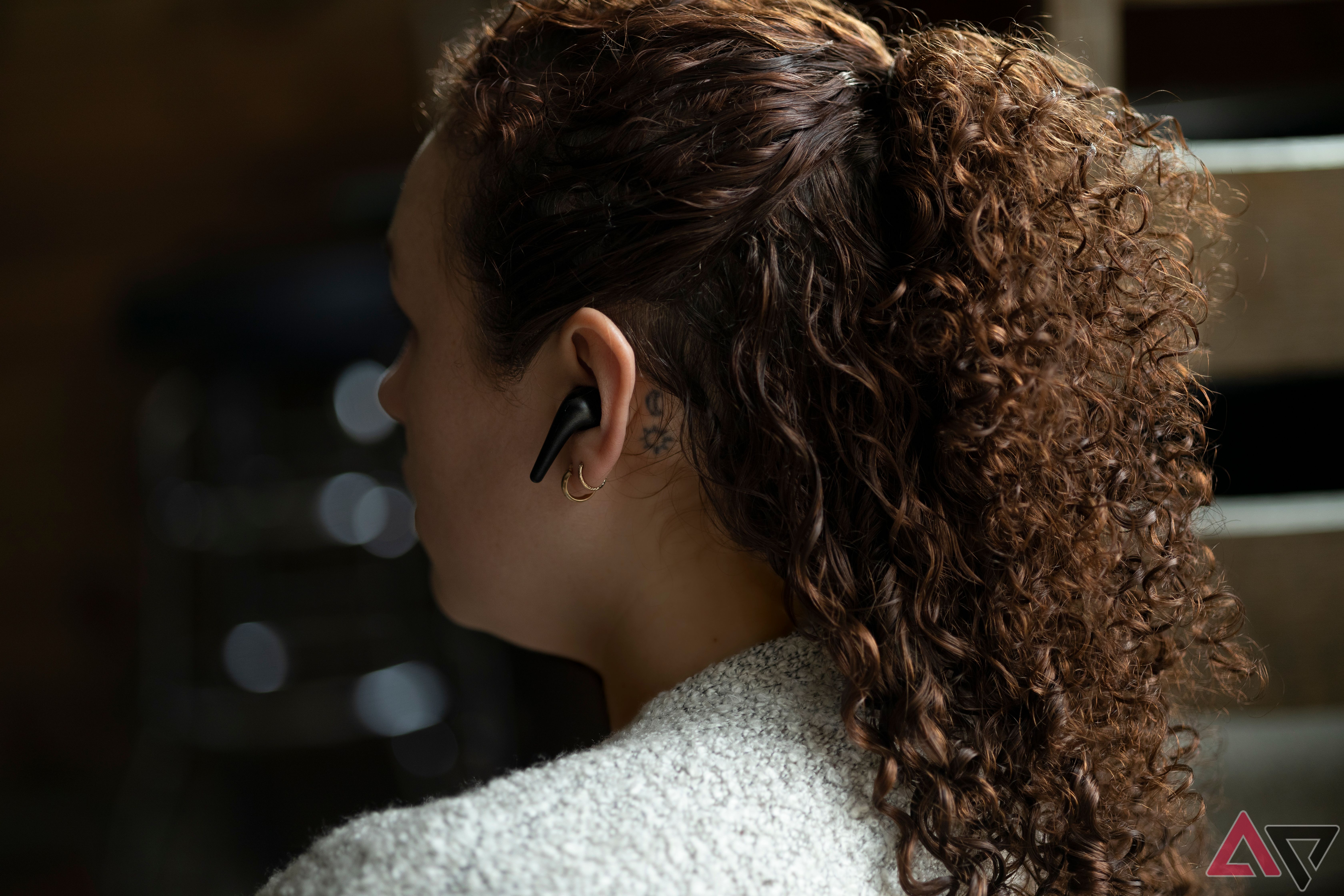 Side angle of woman wearing 1More Aero True Wireless ANC Headphones