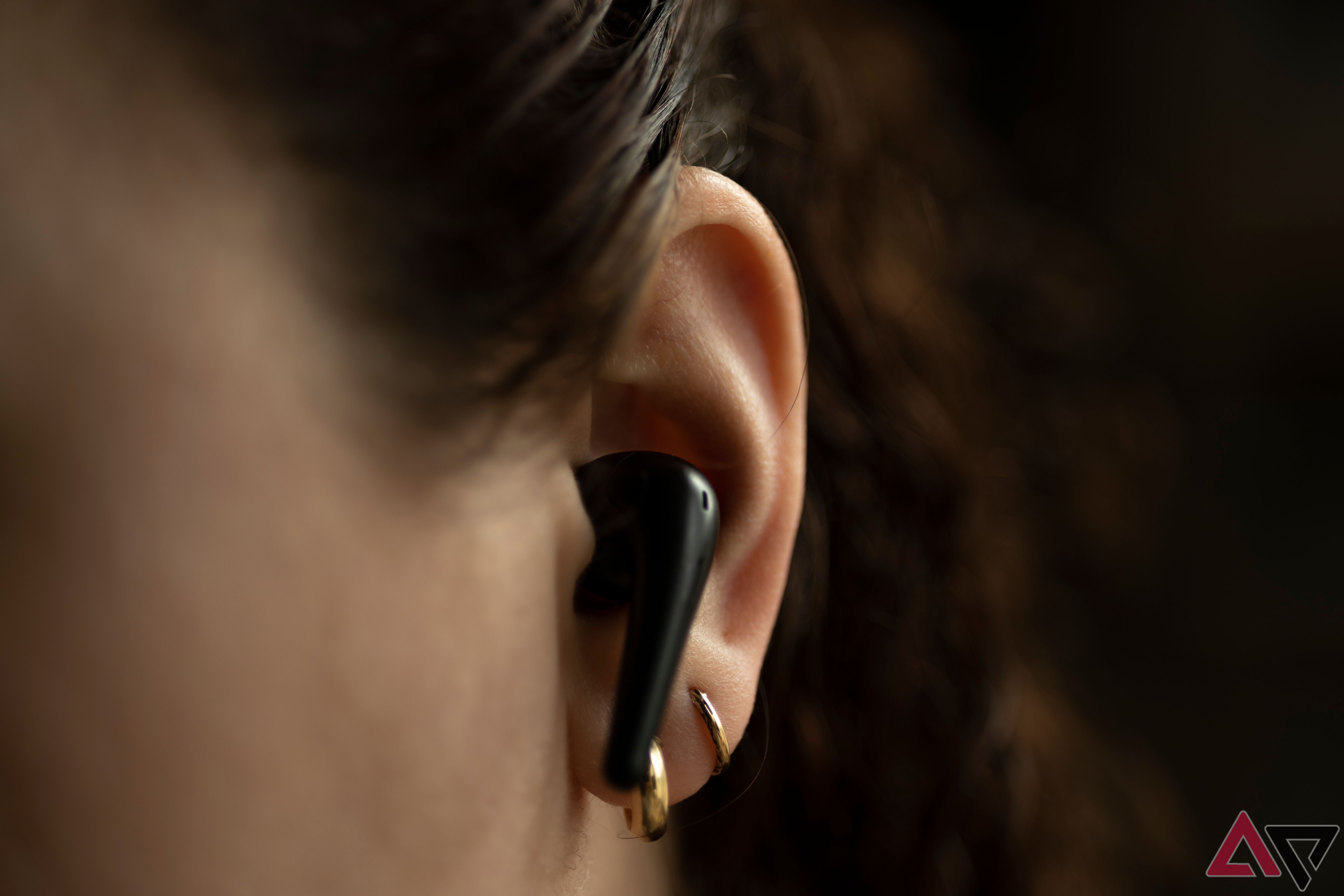 Close-up of a 1More Aero earphone in a woman's ear