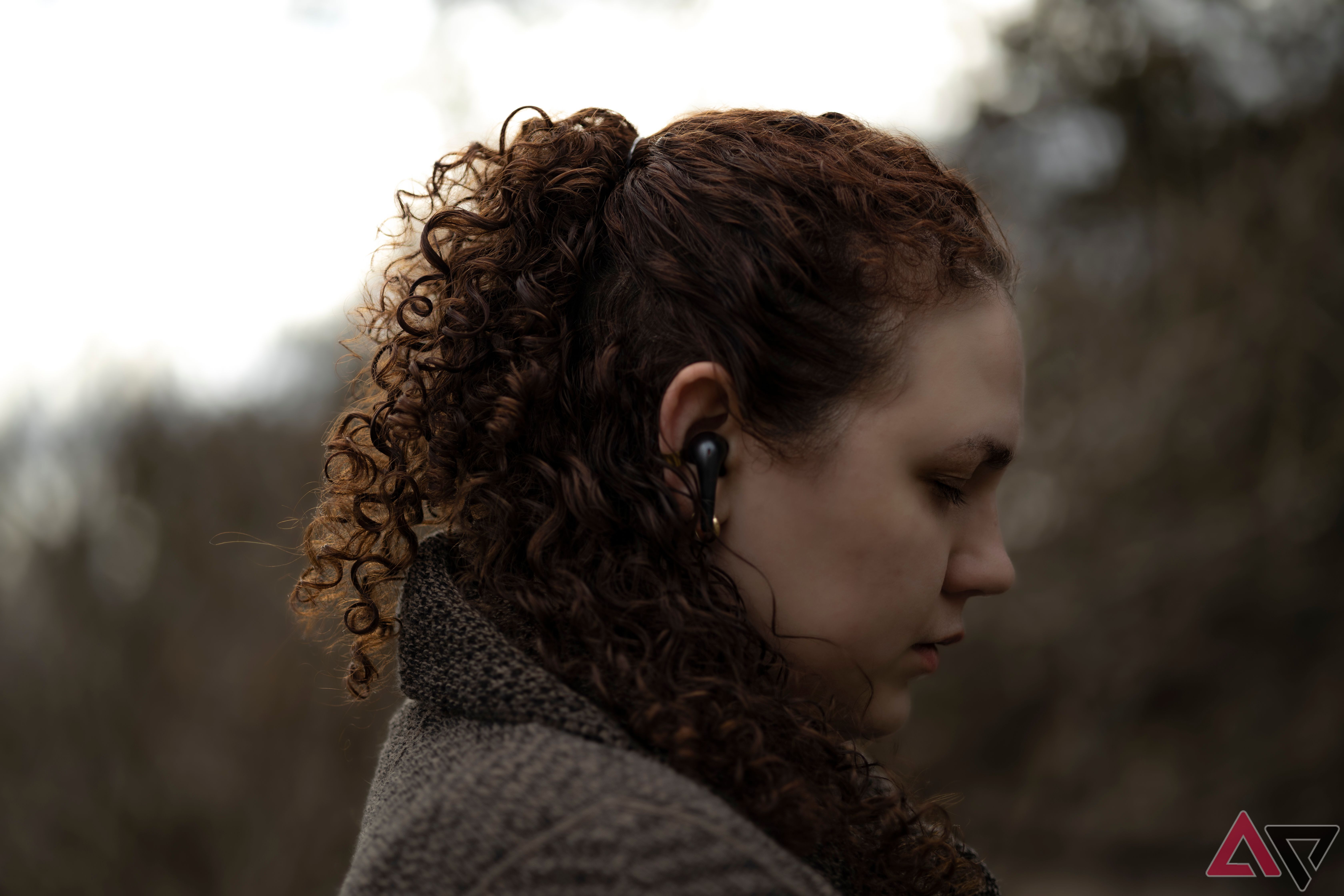 SIde profile of woman wearing 1More Aero True Wireless ANC earbuds