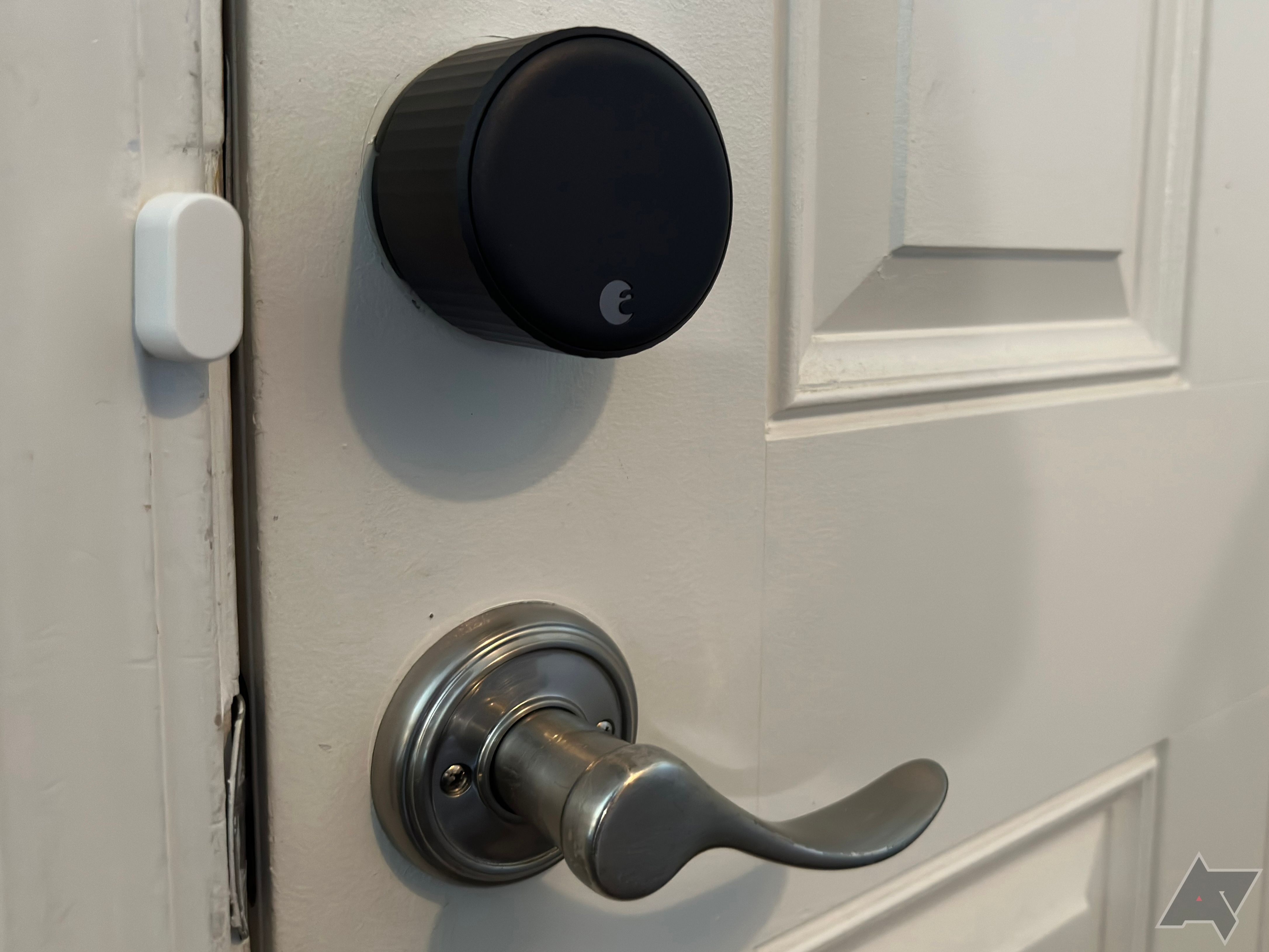 August's wif-fi smart lock attached to a door