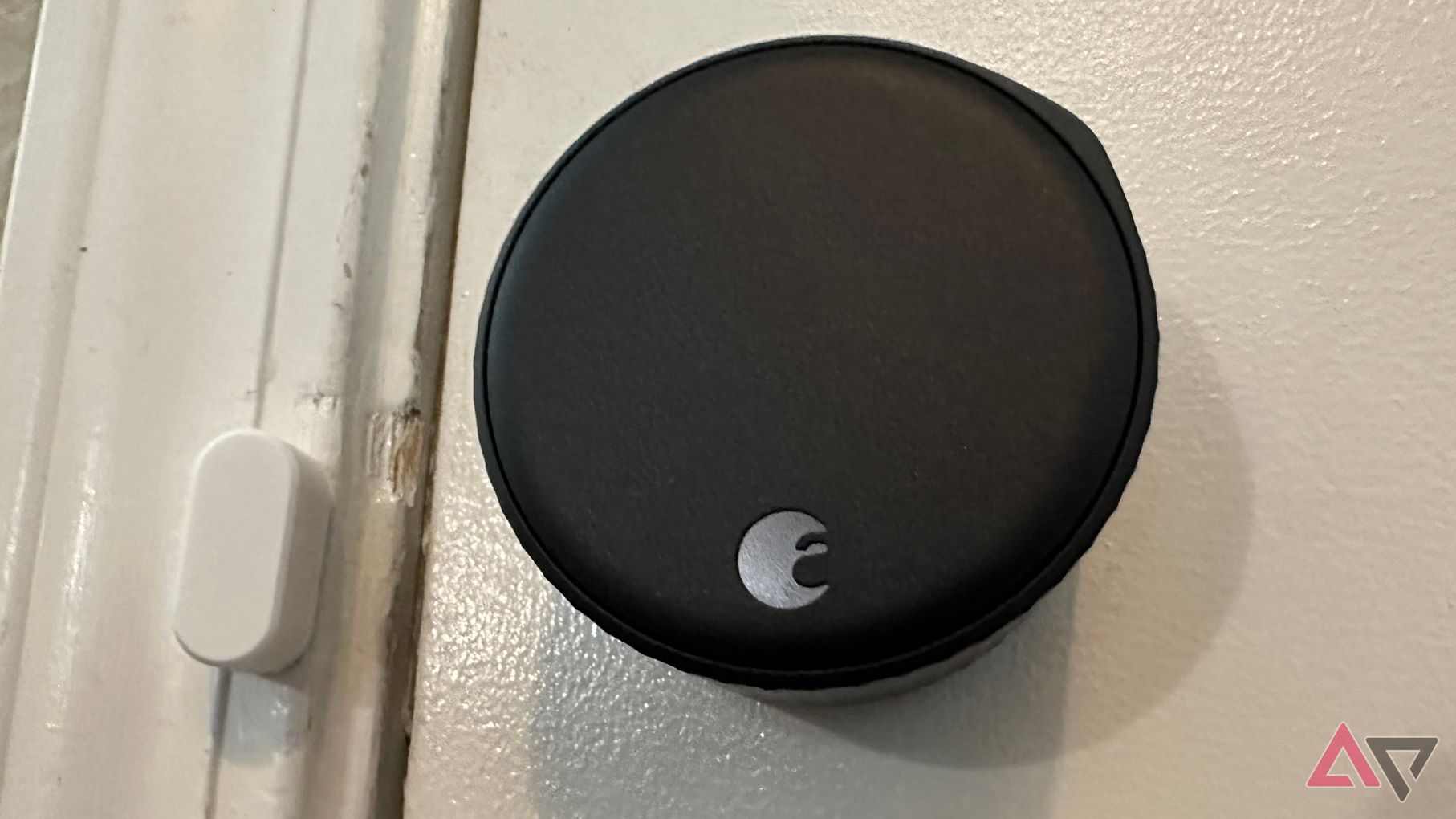 A straight-on photo of the August Wi-Fi Smart Lock and sensor