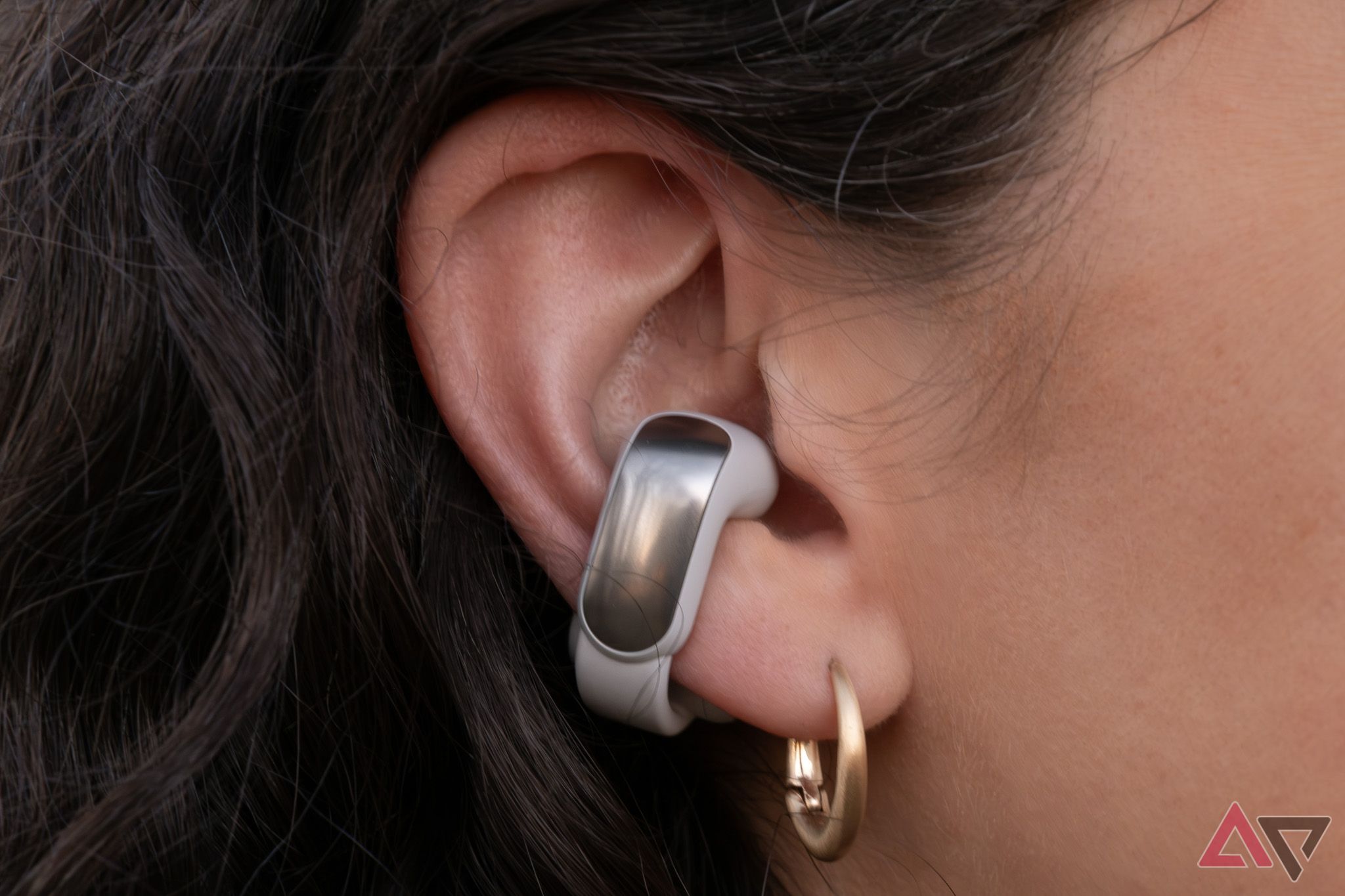 A Bose Ultra Open Earbud on an ear.
