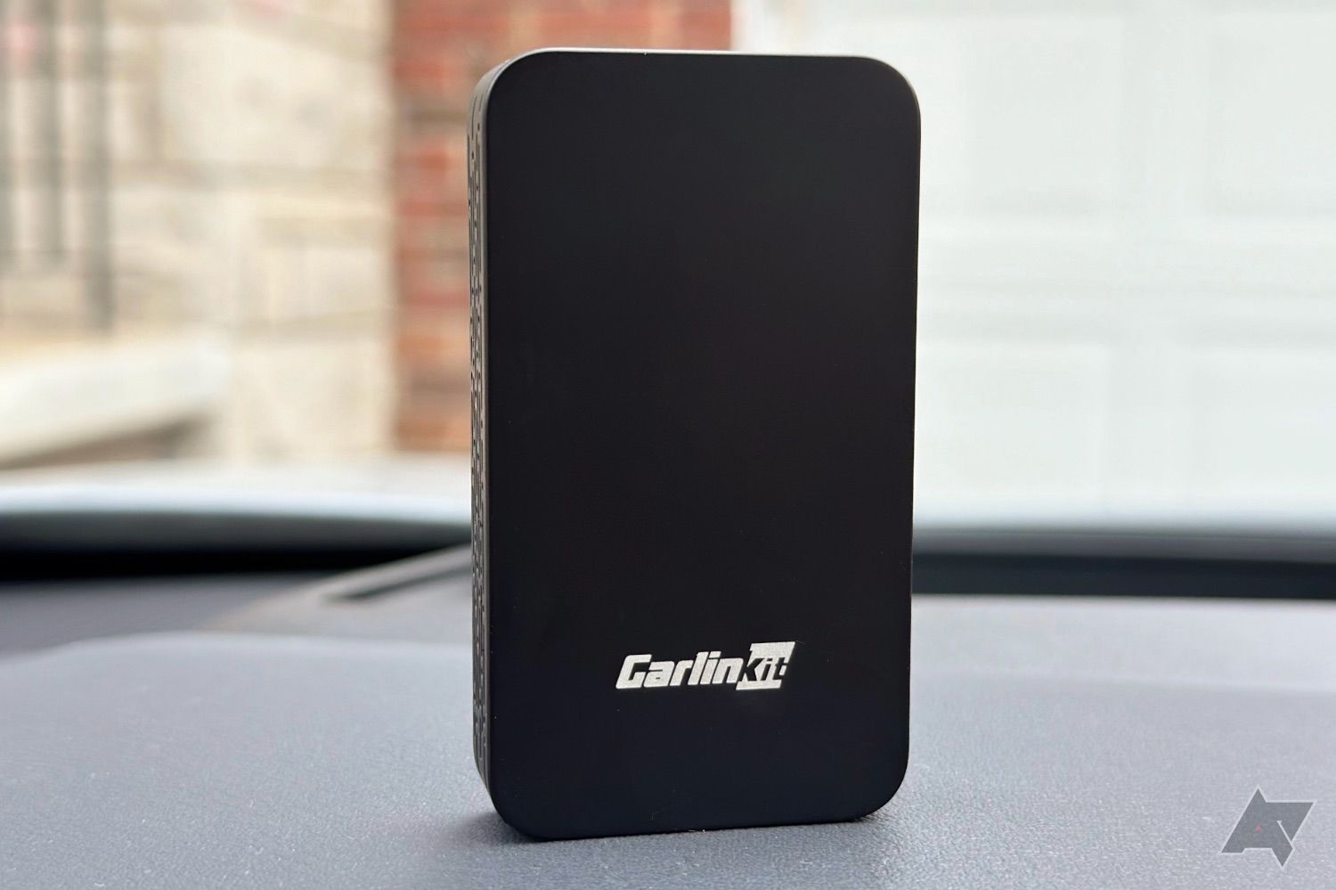 Carlinkit 5.0 adapter on car dashboard.