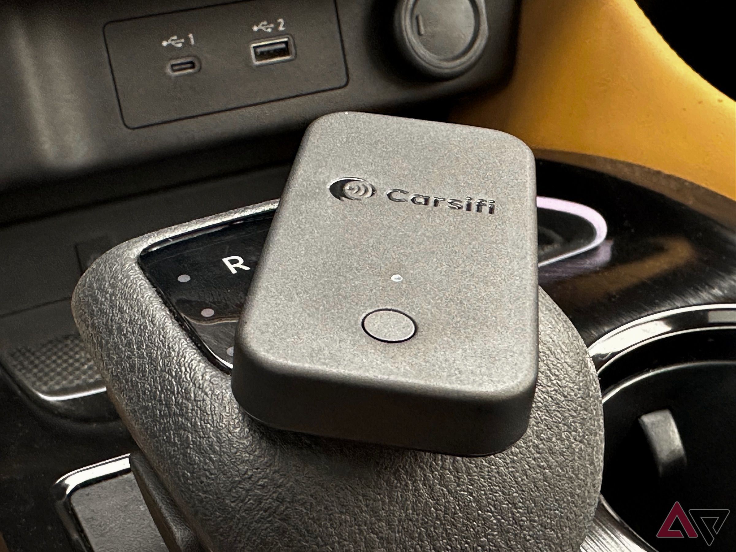 Carsifi Wireless Android Auto Adapter sitting on top of gear shift.