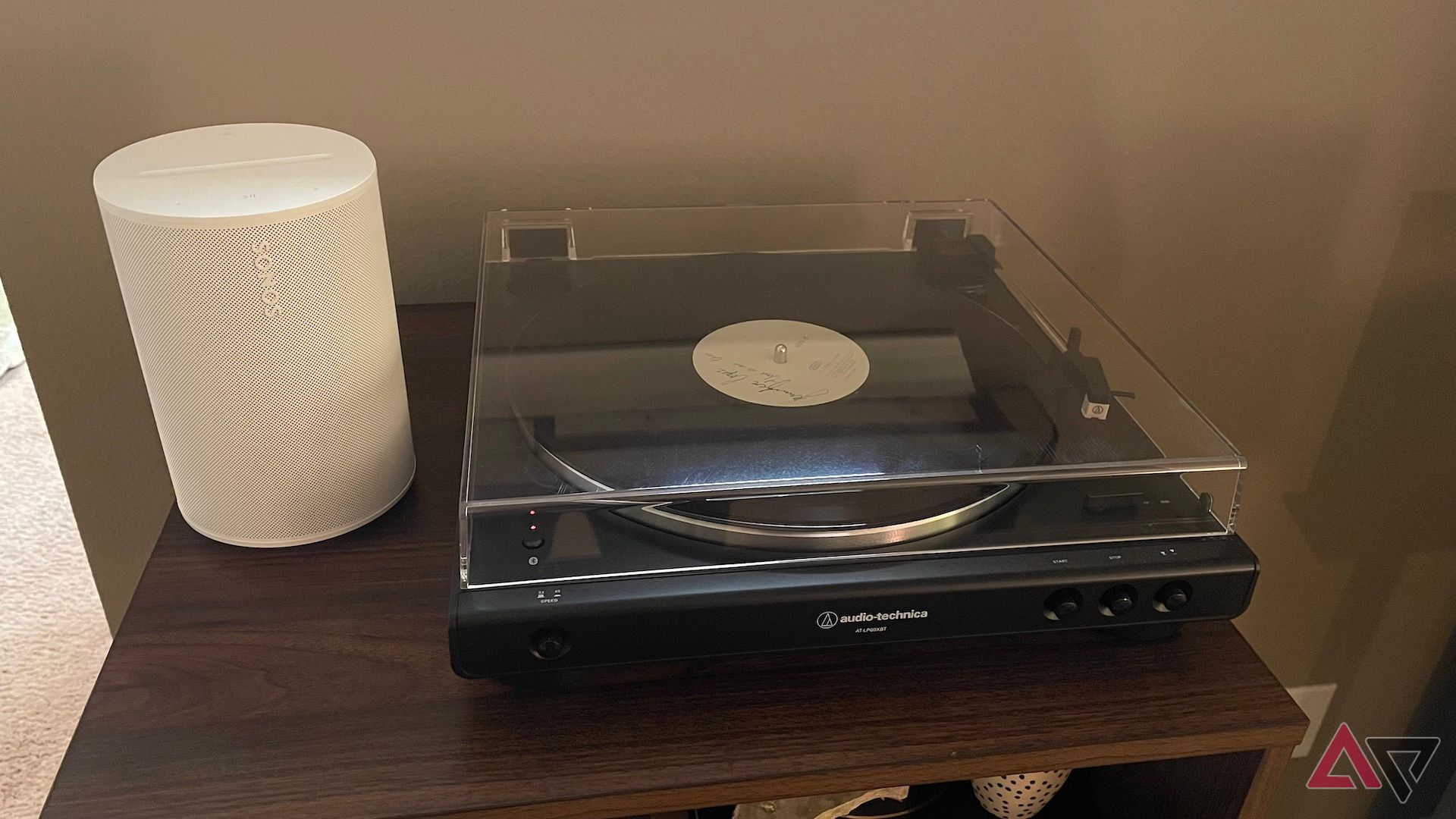 The Sonos Era 100 next to a record player