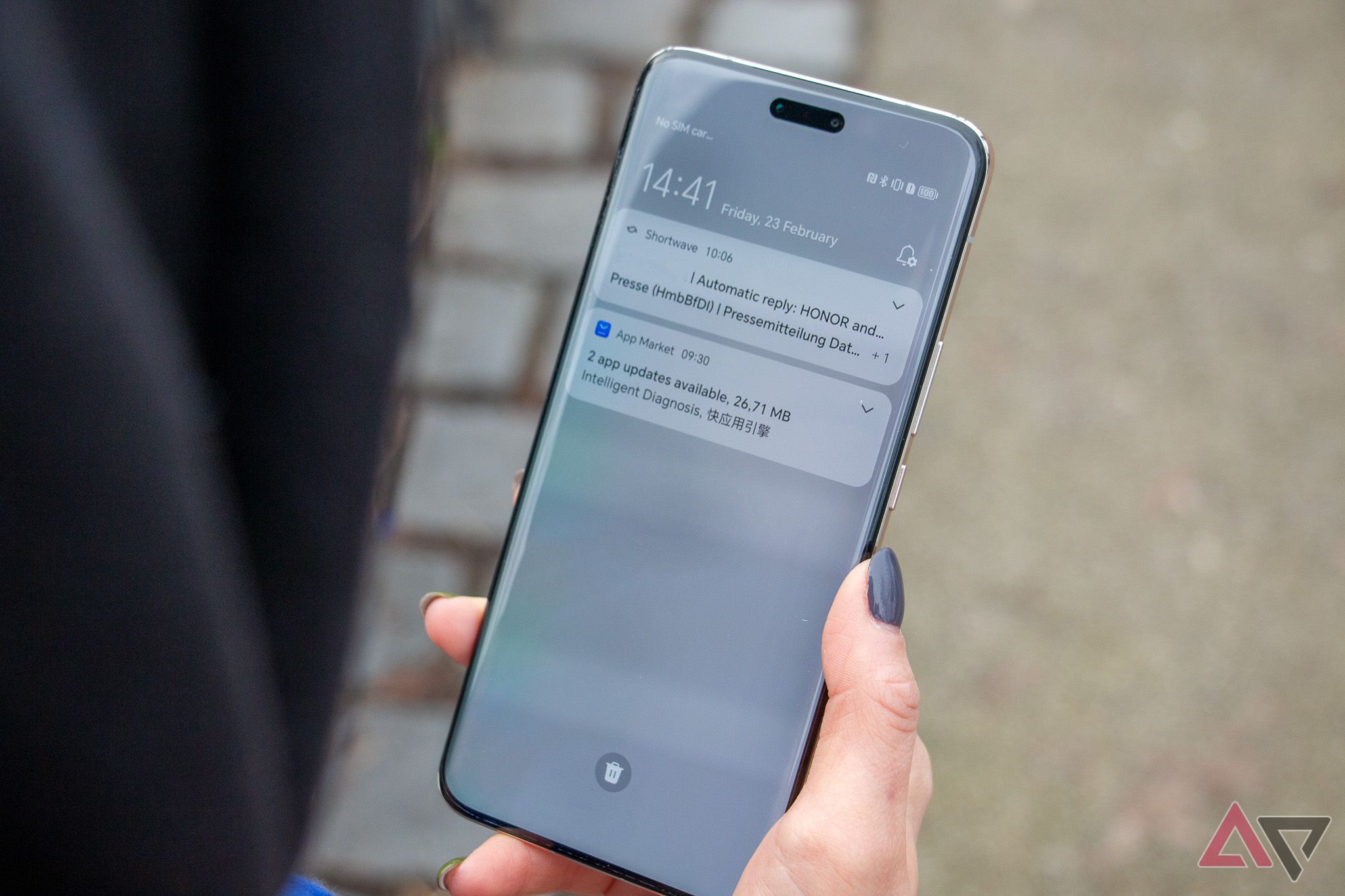 The Honor Magic 6 Pro held in one hand, with the notification shade opened