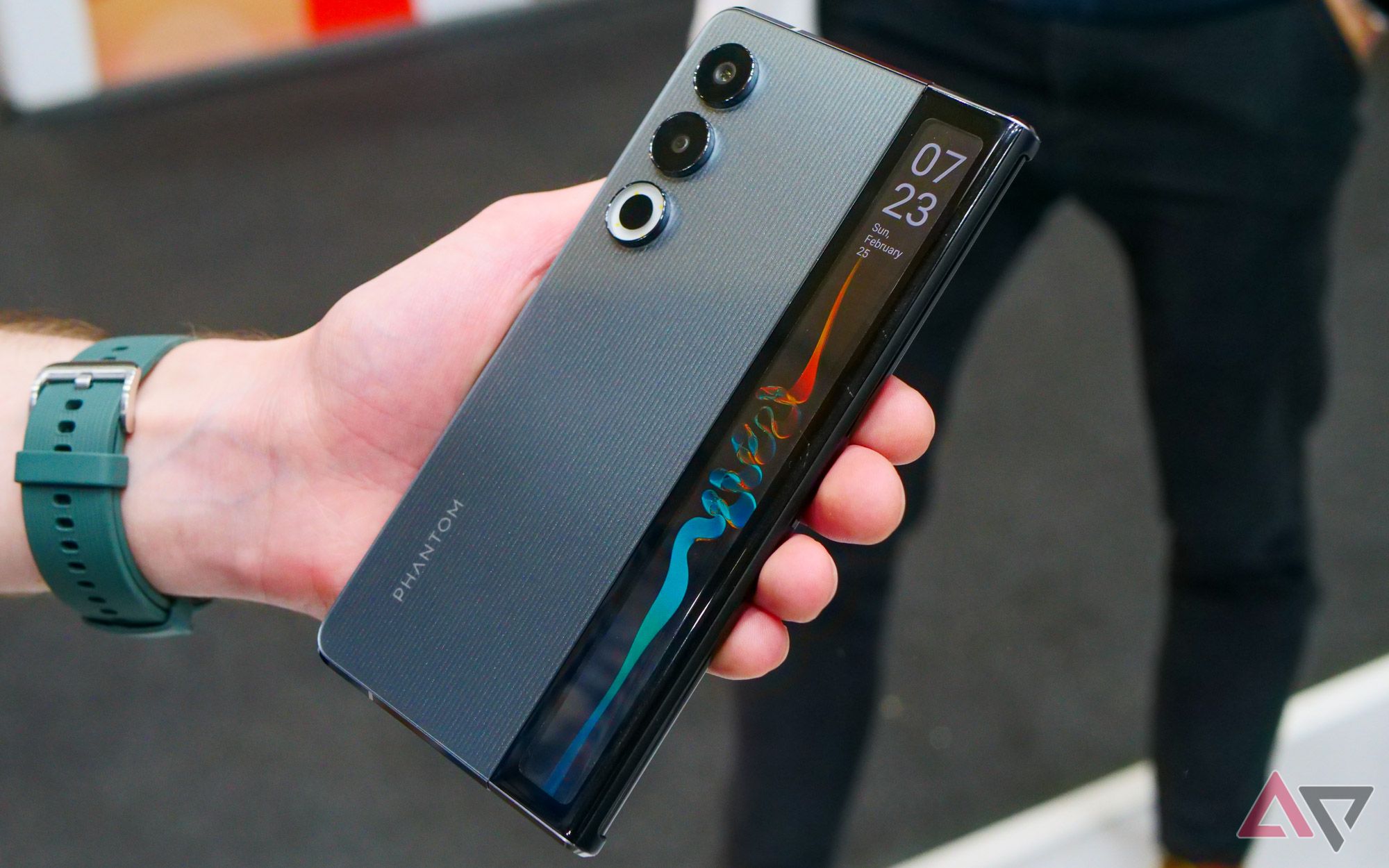 Tecno's rollable concept phone shown from the back, with the exterior screen turned on.