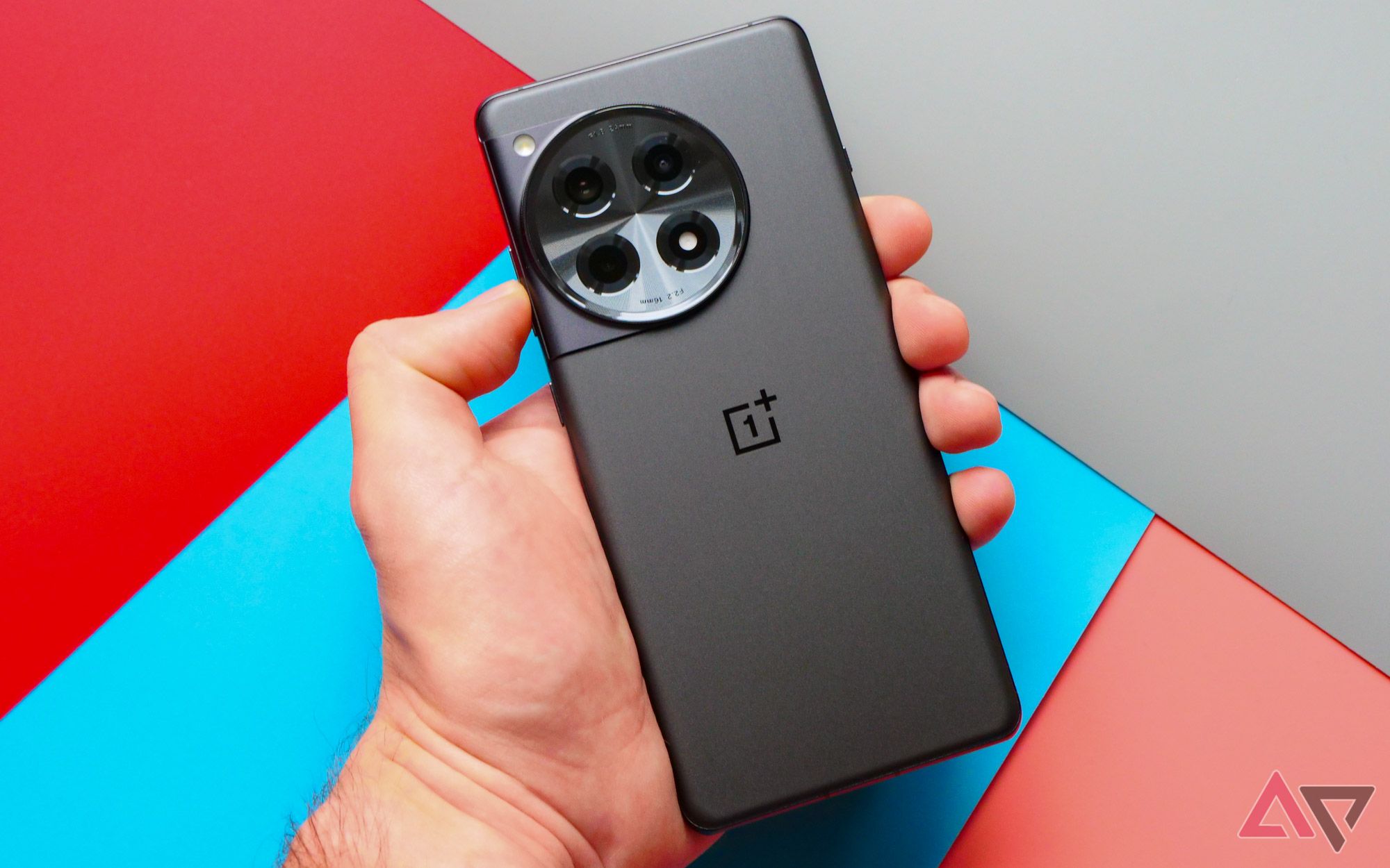 The OnePlus 12R held facedown in a hand