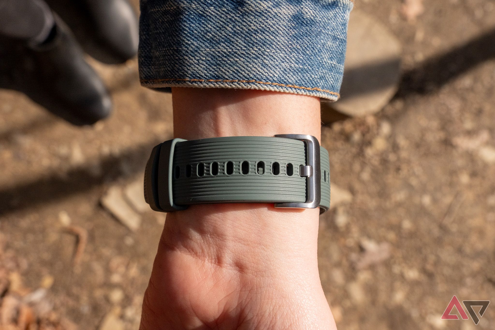 A green watch band on a woman's wrist