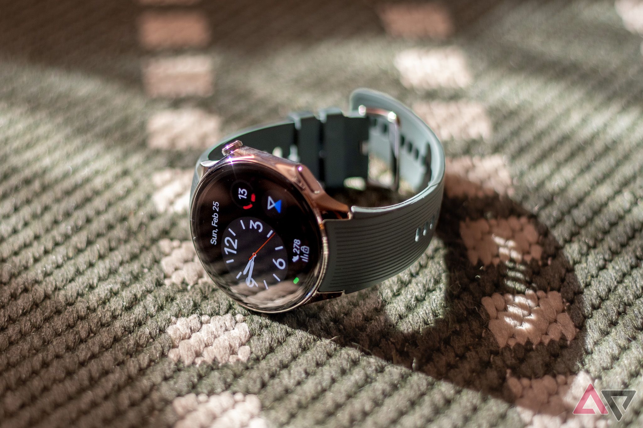 A smartwatch sitting on a green rug