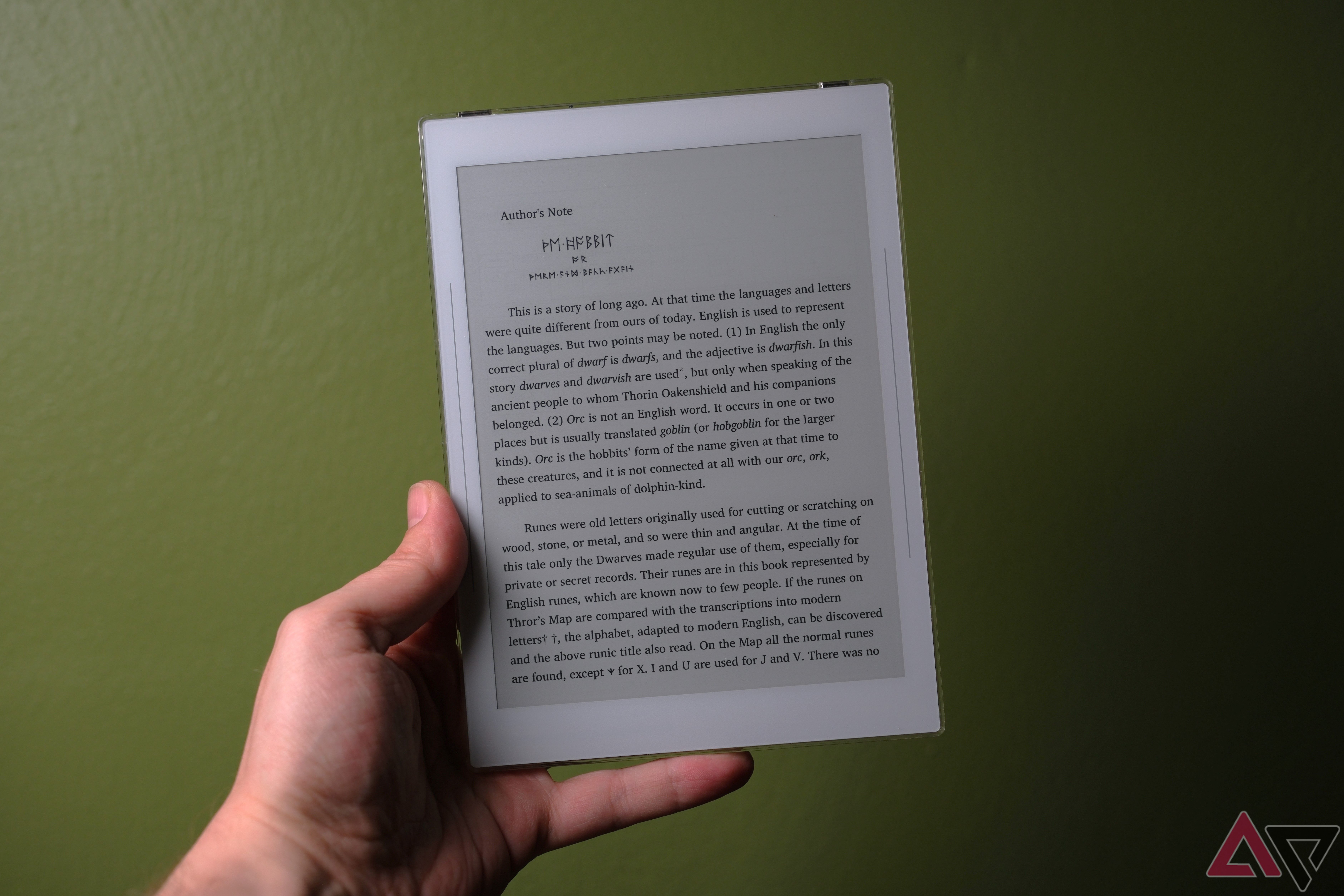 Supernote Nomad held in hand showing epub on screen with green background