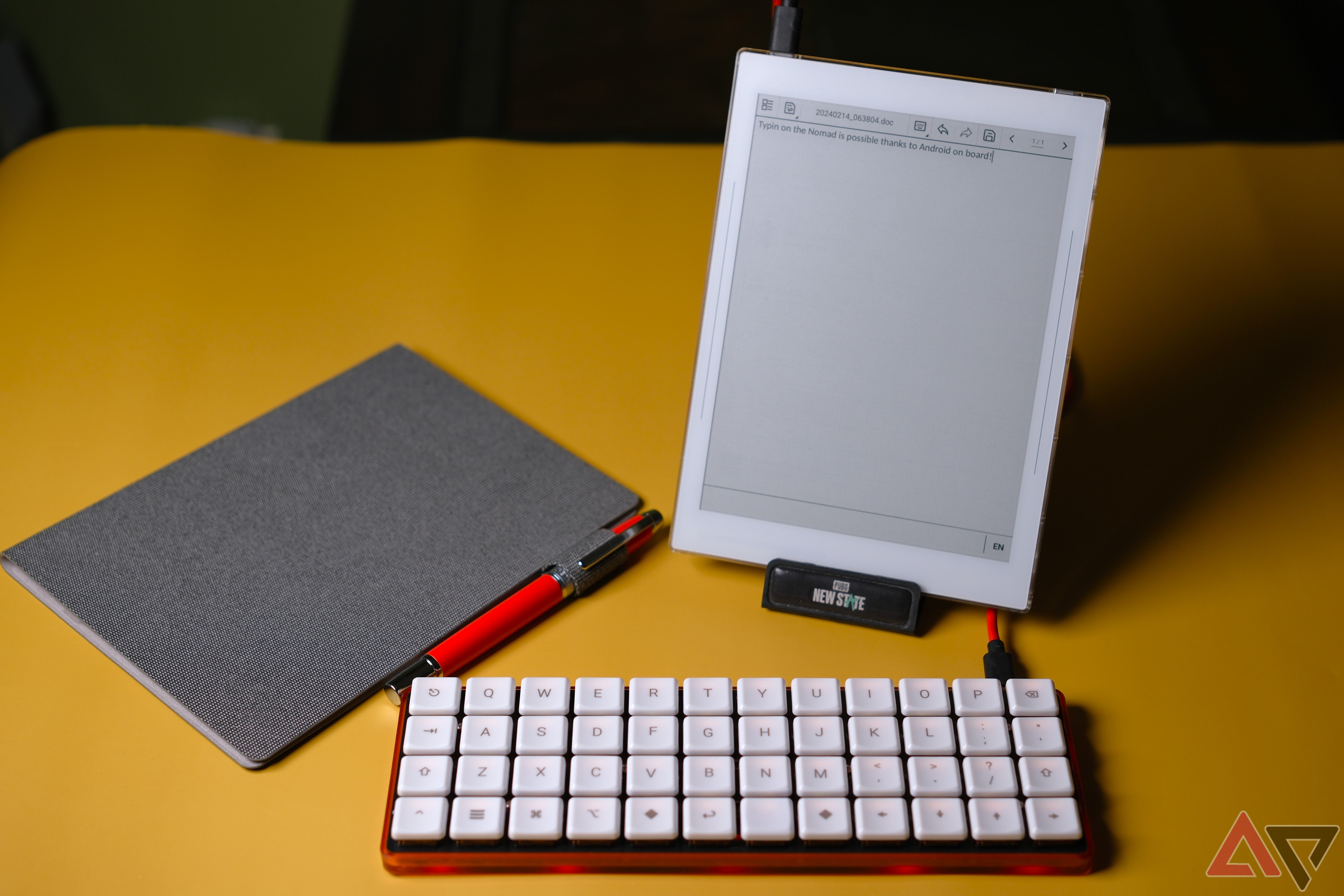 Supernote Nomad setup to write with keyboard while standing on yellow background