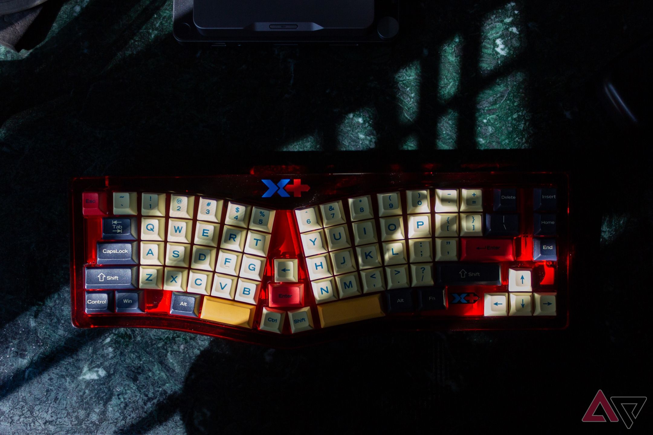 Moody photograph of the VickyBoard on a green marble desk with sunlight and shadows illuminating parts of the keyboard