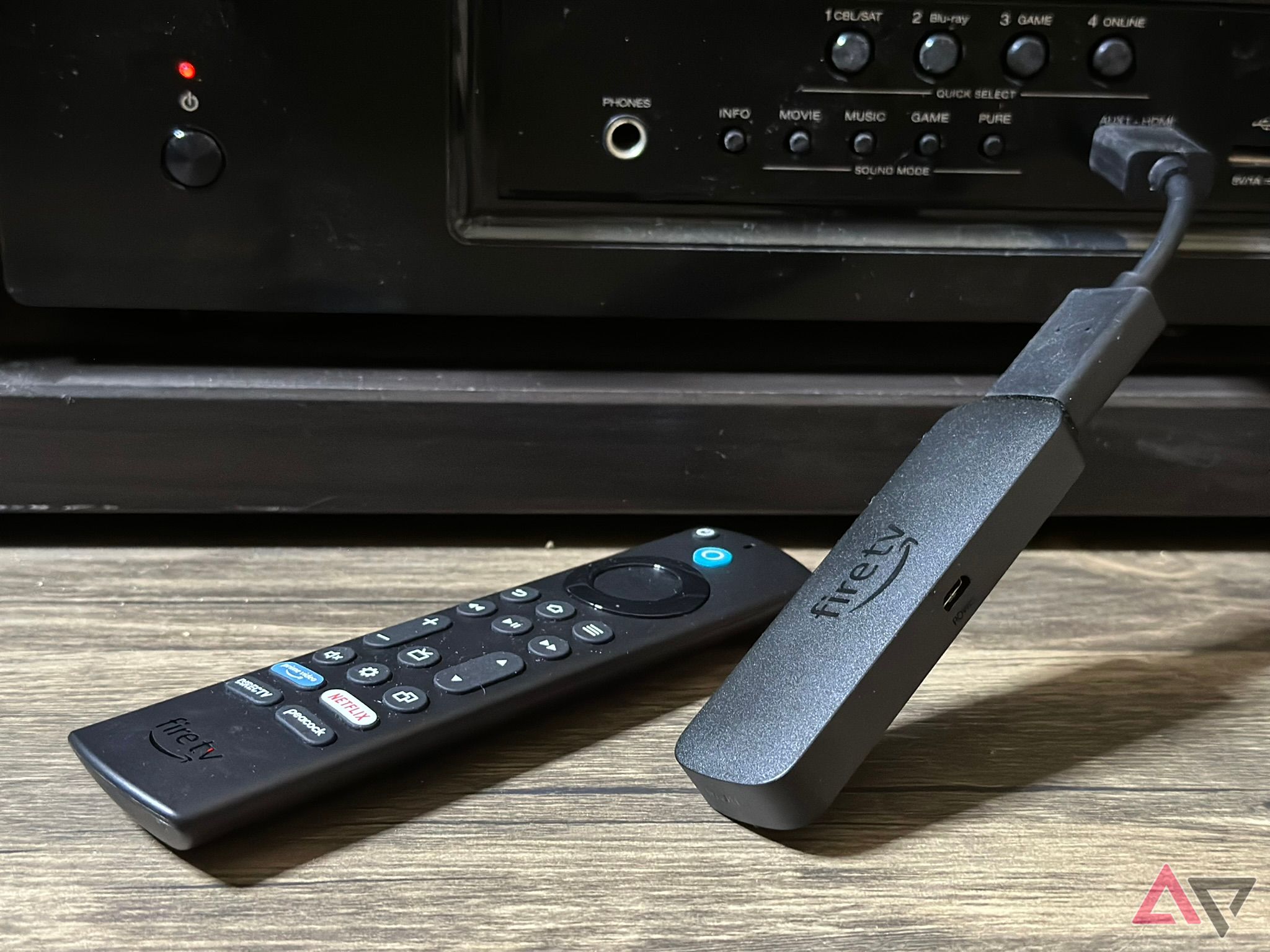 The Fire TV Stick 4K Max and remote, in front of a receiver