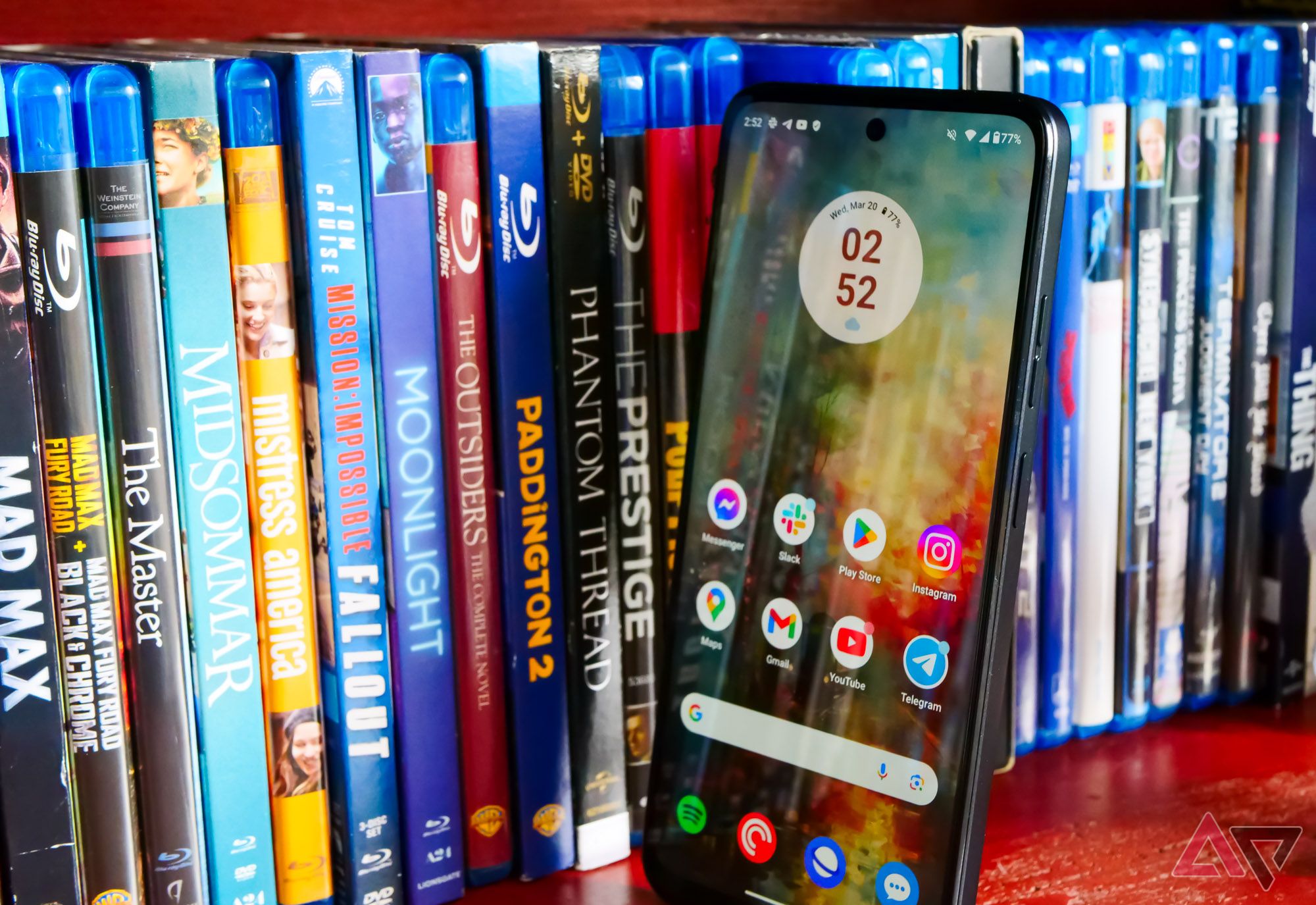 The Moto G Power (2024) next to movies, standing straight up.