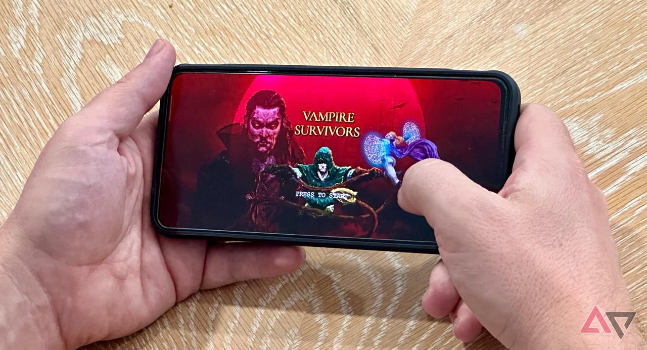 Man playing Vampire Survivors on a smartphone
