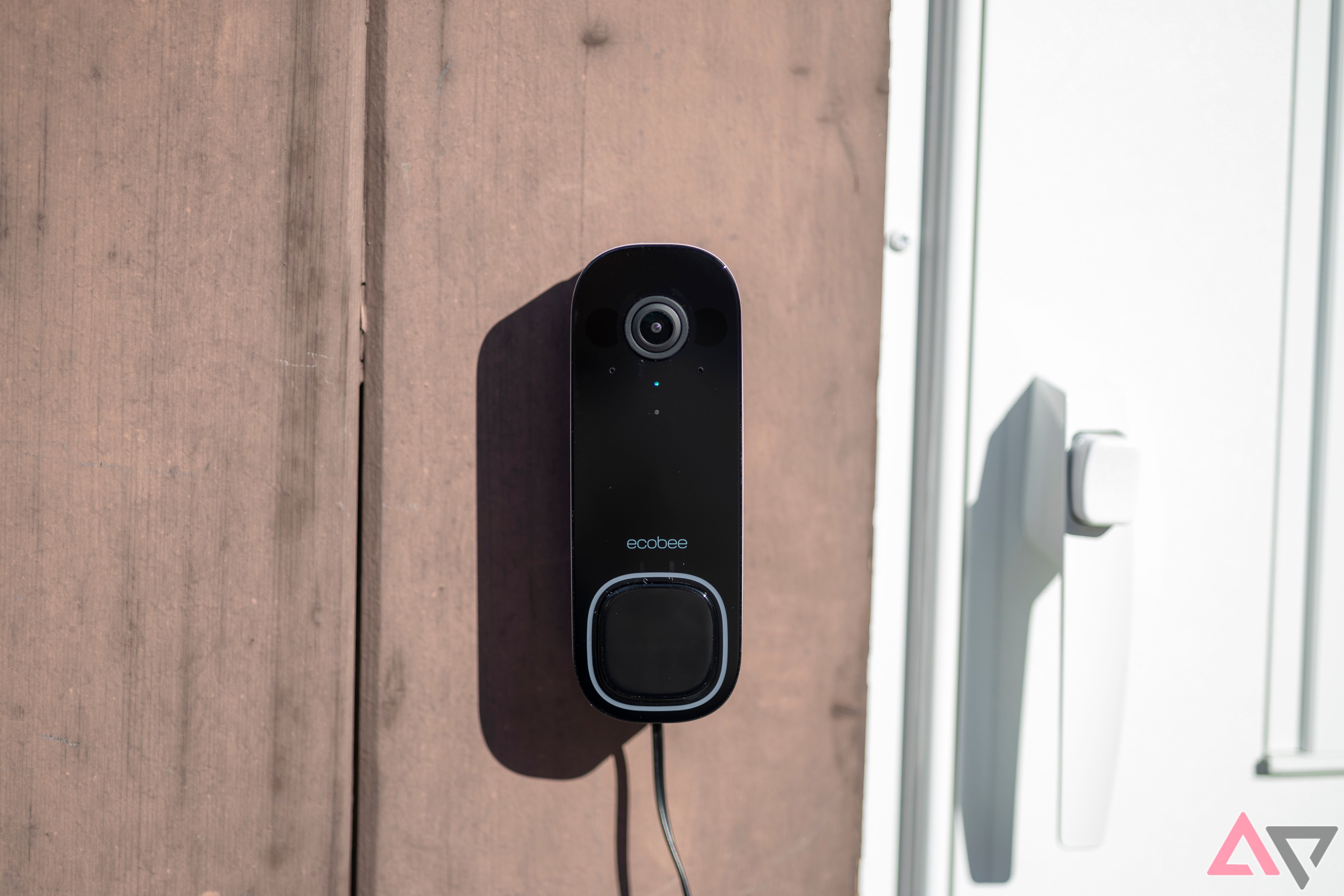 Ecobee Smart Doorbell Camera (Wired) next to white patio door