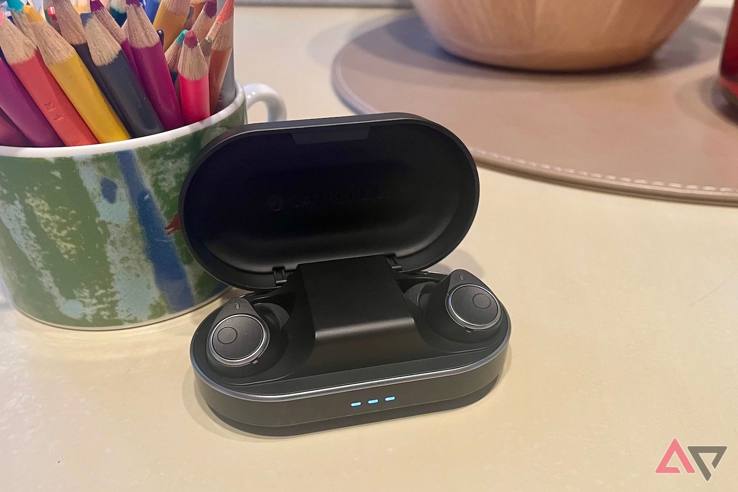 The Cambridge Audio Melomania M100 earbuds inside the opened charging case.