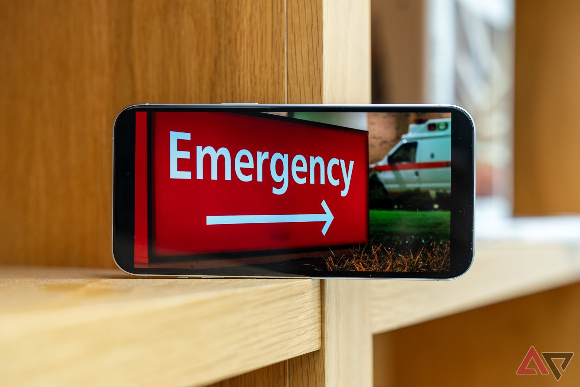 An iPhone showing a picture of an Emergency room sign