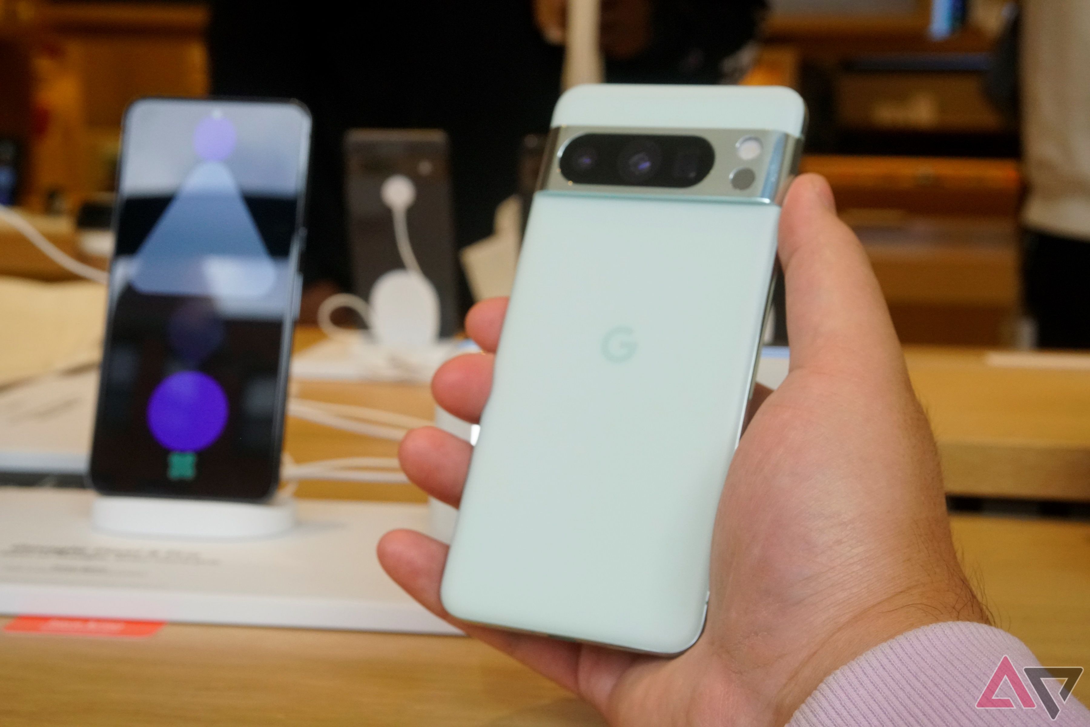 A Mint Google Pixel 8 Pro held in a hand.