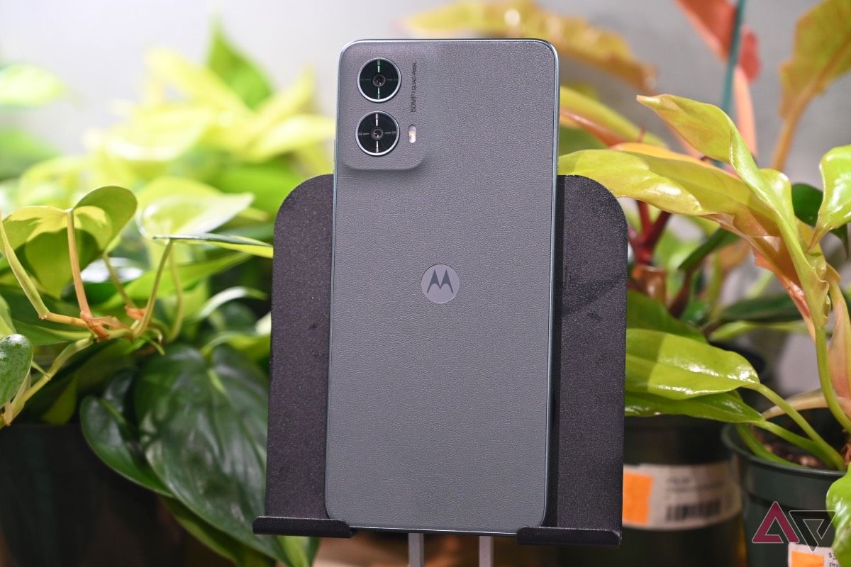 Sage green vegan leather rear panel of the Moto G 5G with plants in background