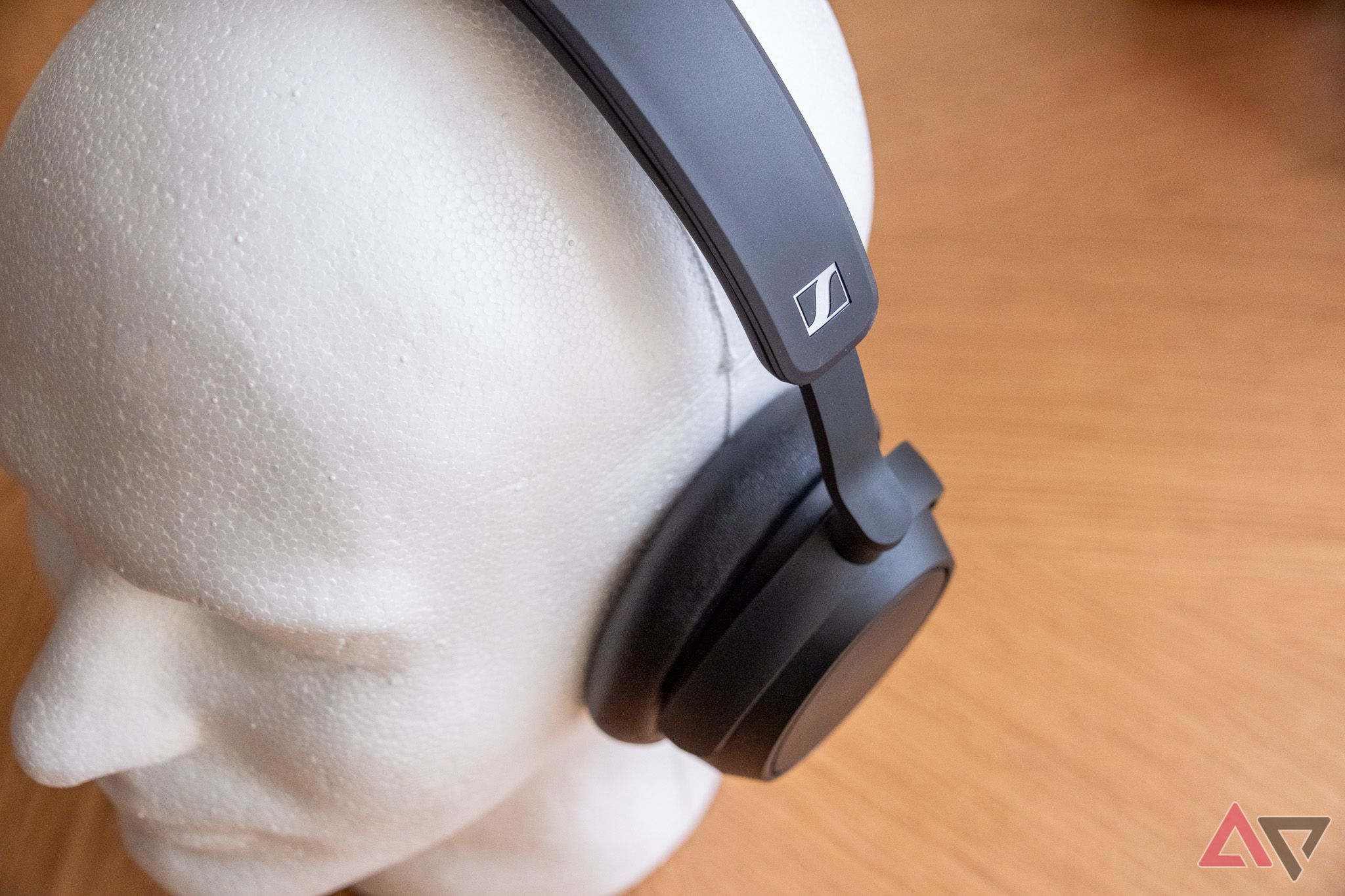 A styrofoam mannequin head wearing over-ear headphones