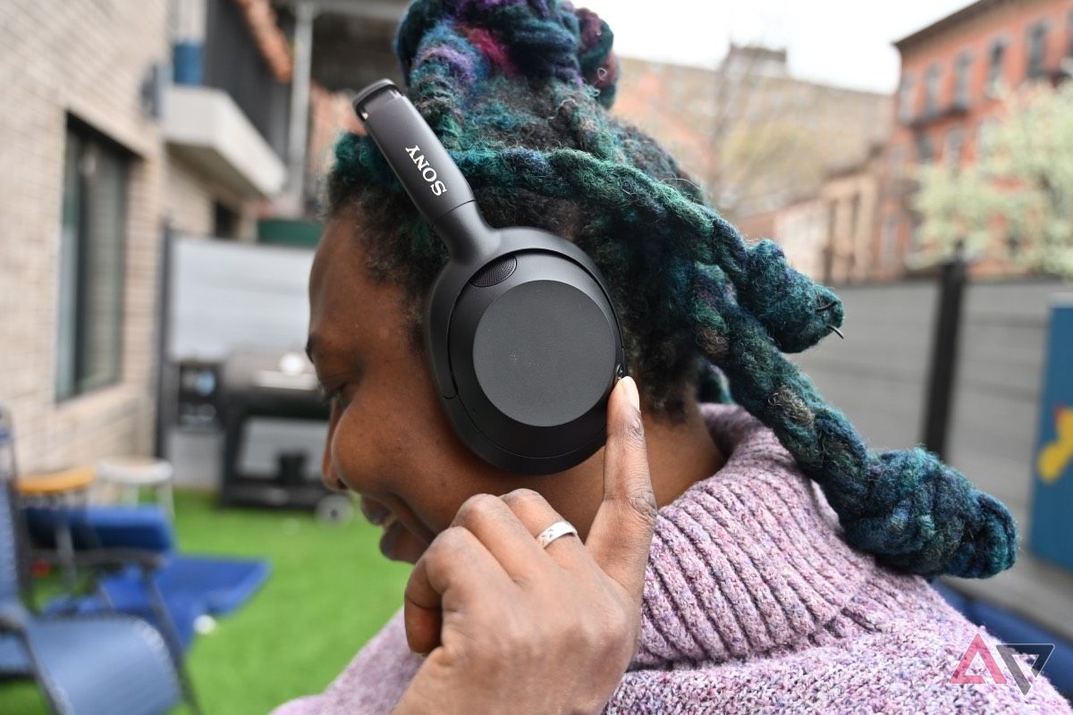 African-American woman touching button on Sony Ult Wear Headphones