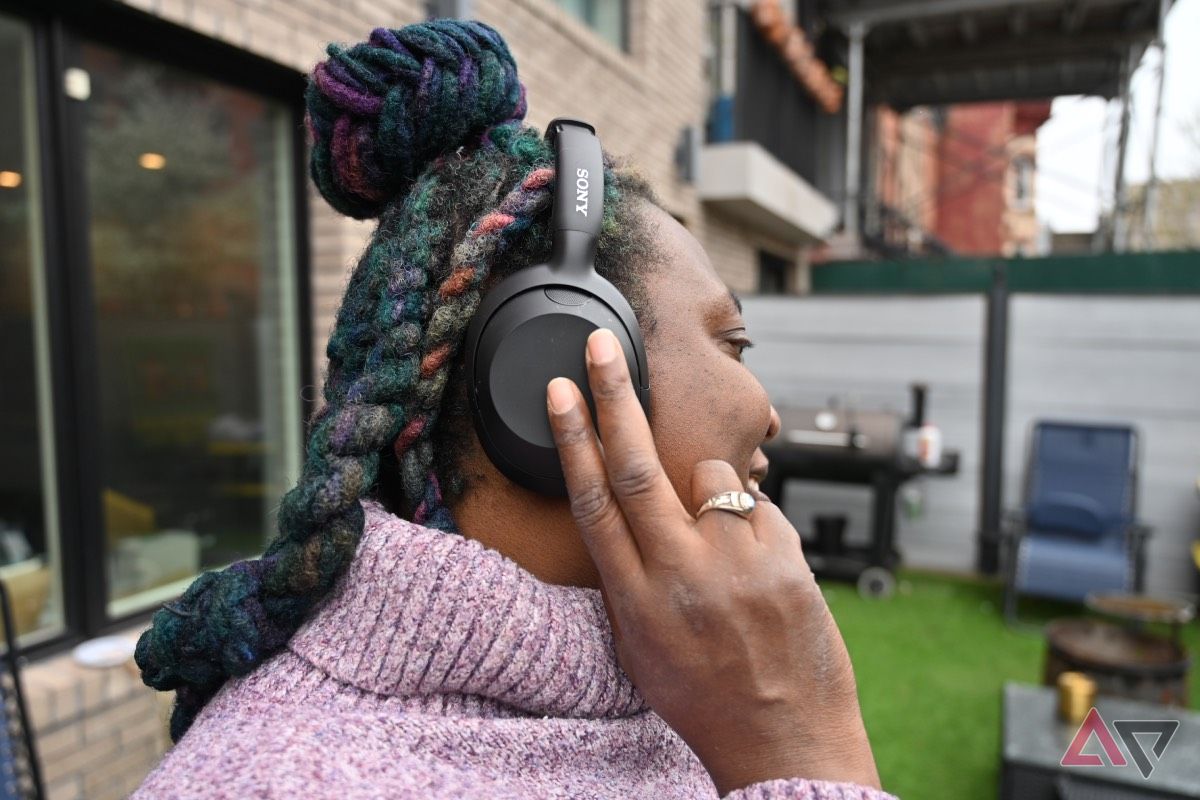 African-American woman interacting with Sony Ult Wear Headphones touch panel