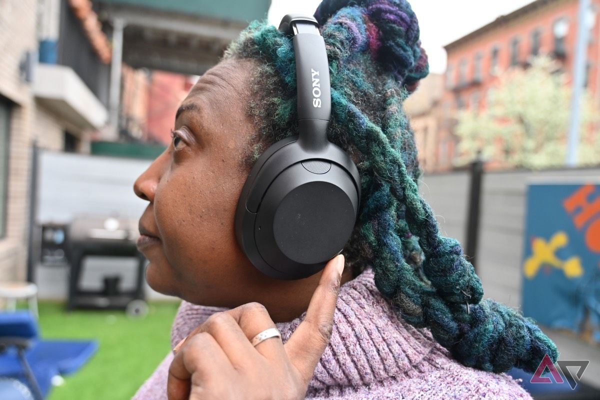 Side shot of African-American woman wearing Sony Ult Wear Headphones