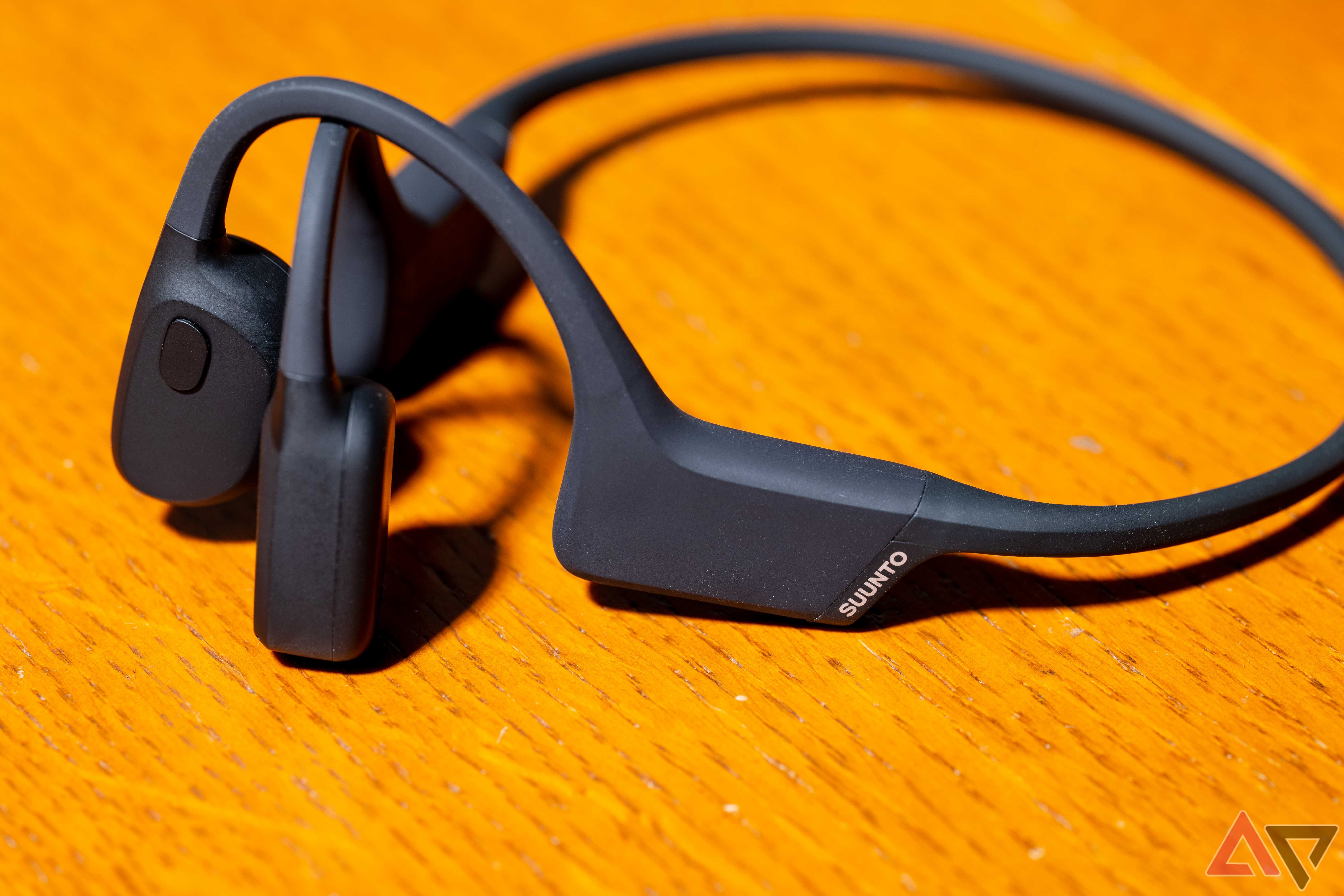 The Suunto Sonic bone conduction headset sitting on a table, seen from the lefthand side.