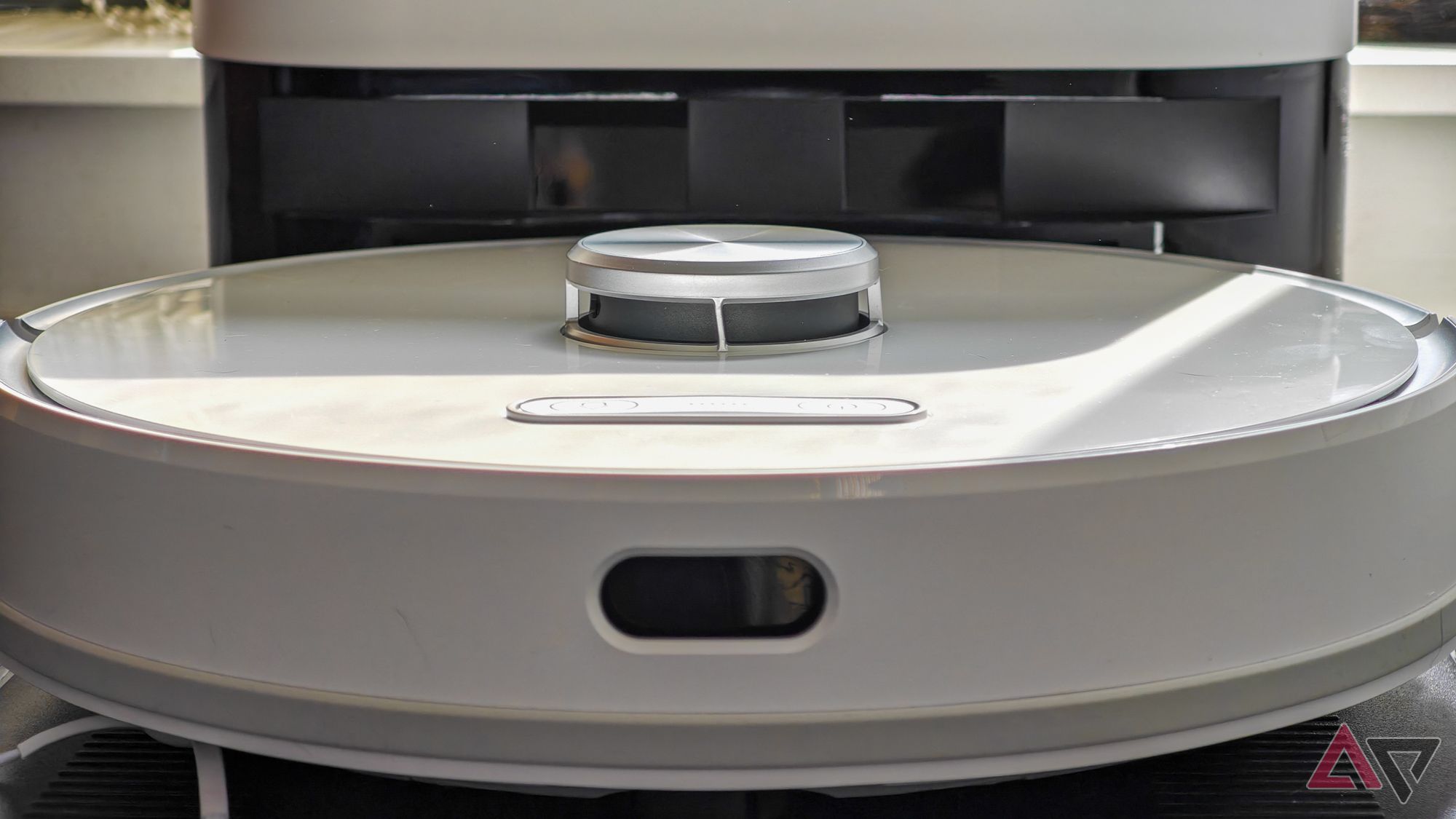 A head-on view of the Ultenic T10 Pro robot vacuum in its docking station, at a low angle