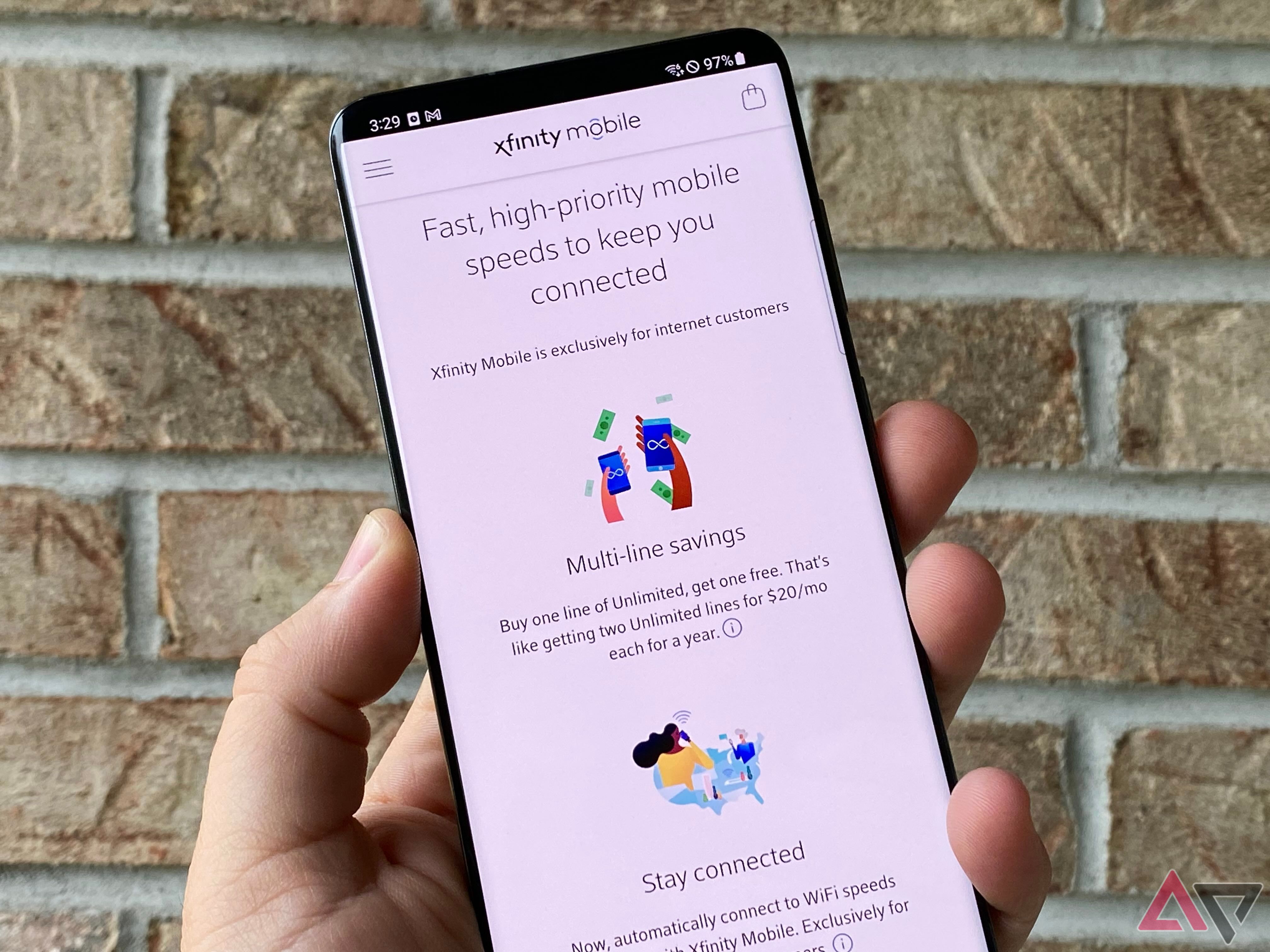 Xfinity Mobile plans page on a phone in front of bricks
