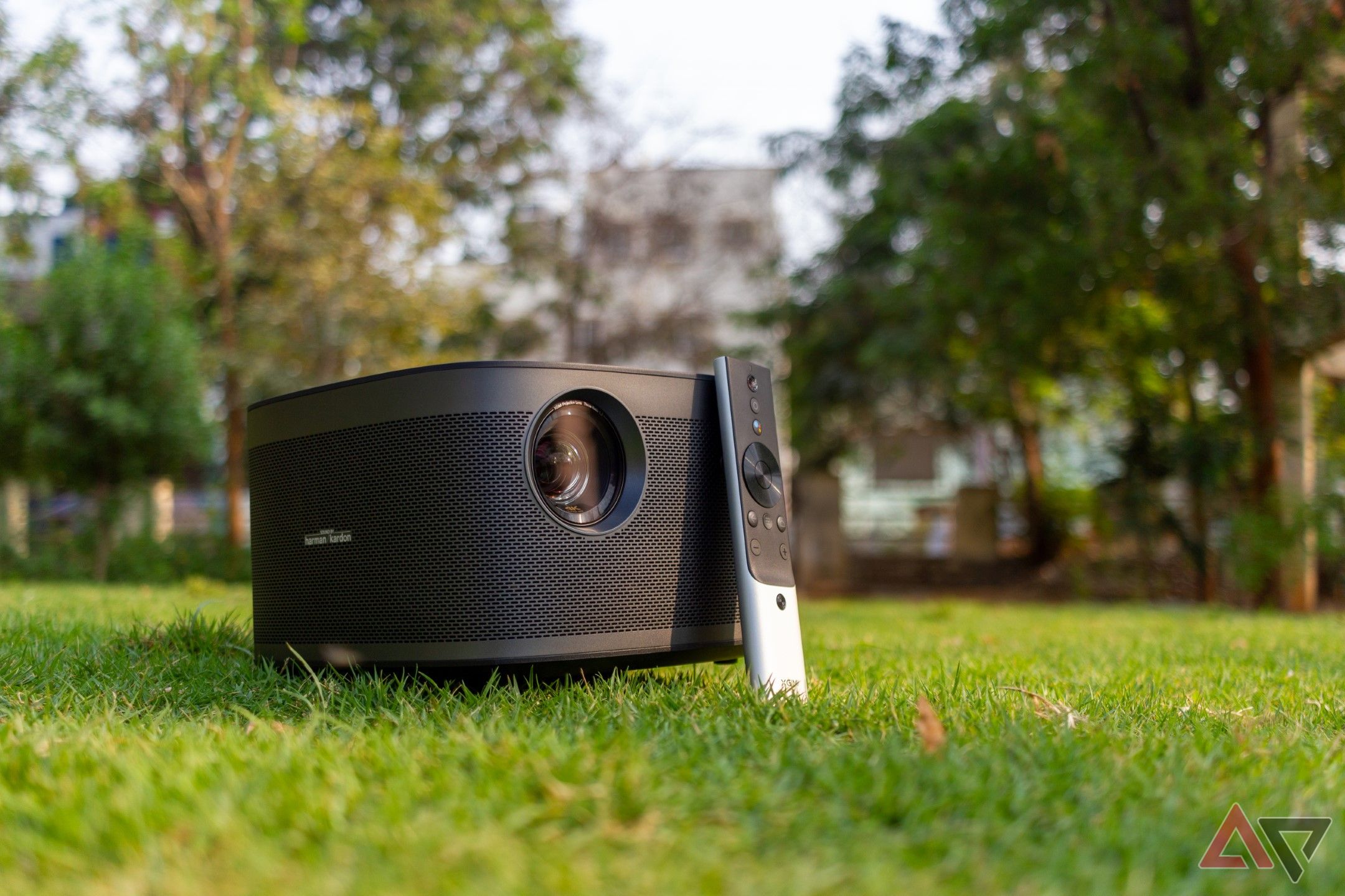 Xgimi Horizon Pro projector and its remote on a green lawn