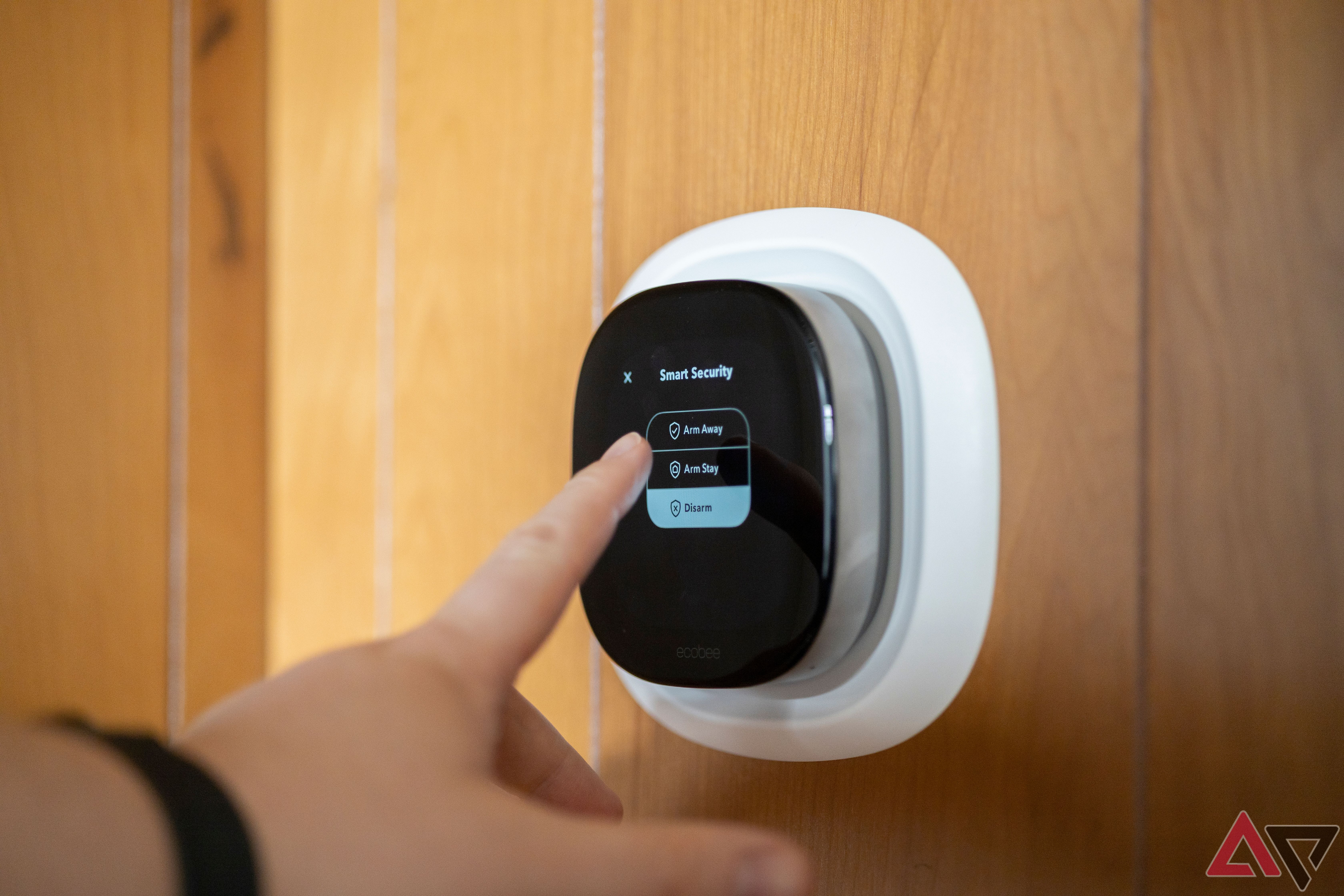 Person arming security system with Ecobee Premium smart thermostat