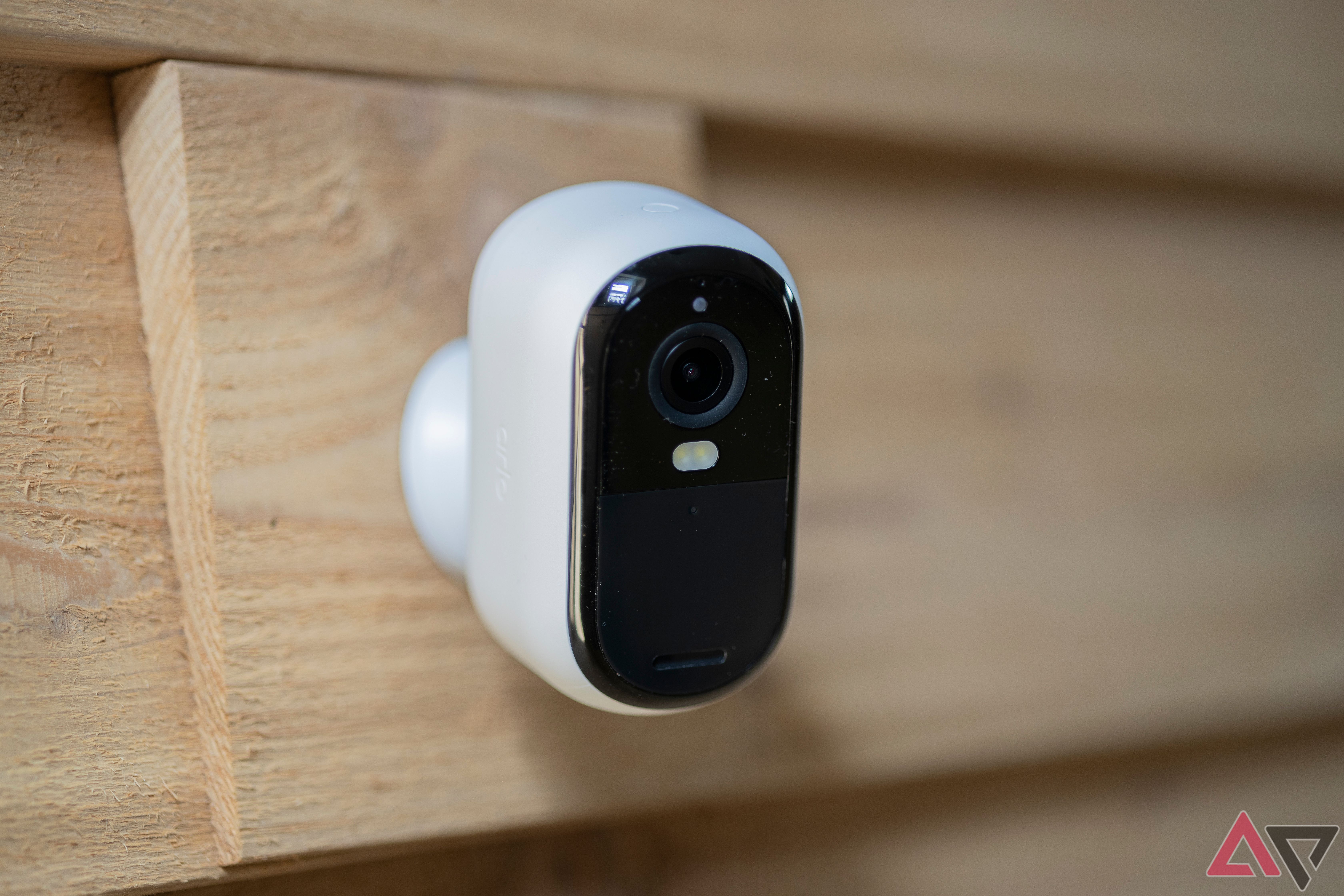 Arlo Essential 2nd Gen Outdoor Camera 2K mounted on wooden wall