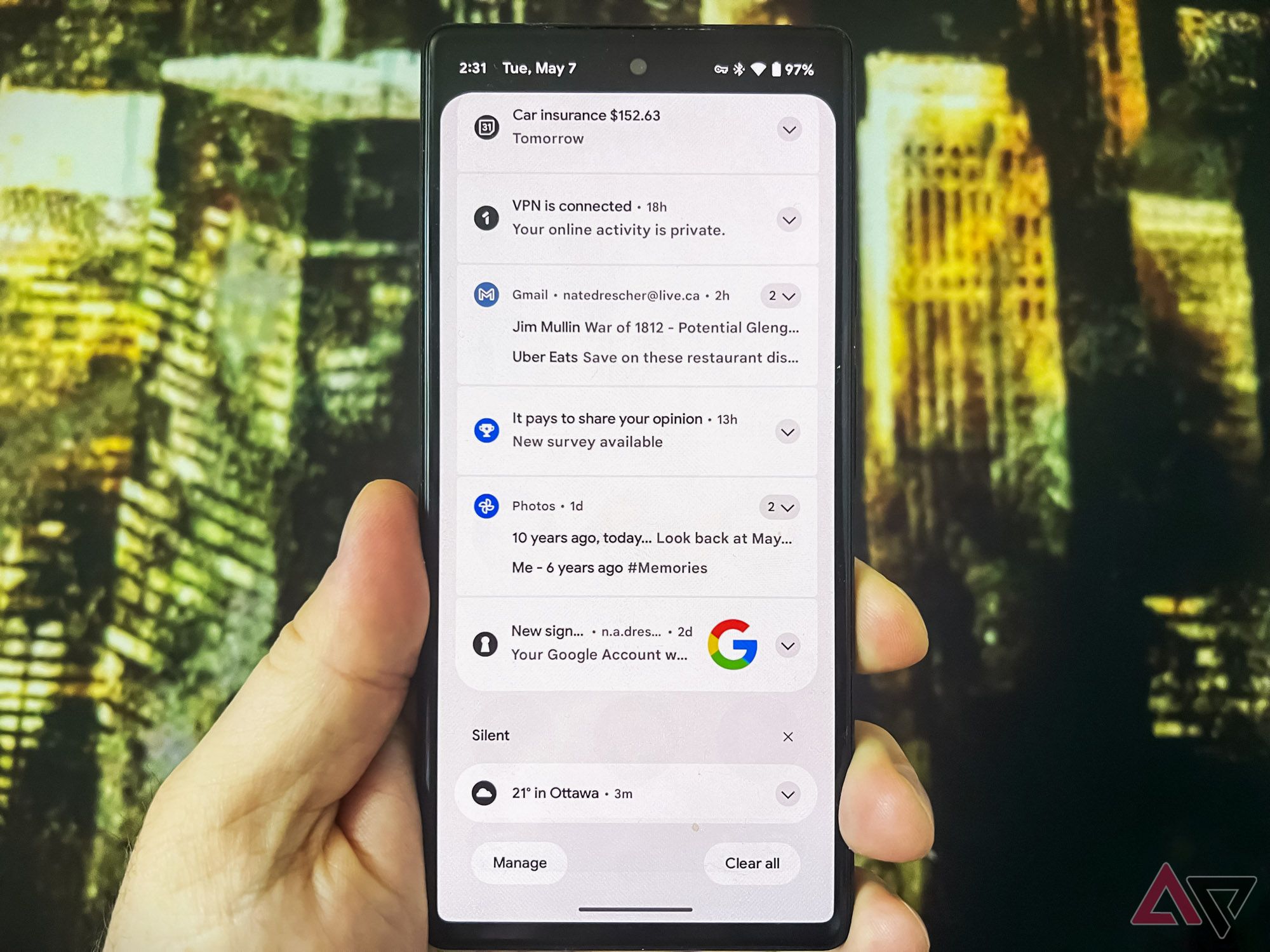 A hand holding a Pixel 6 with a list of different notifications showing on the screen.