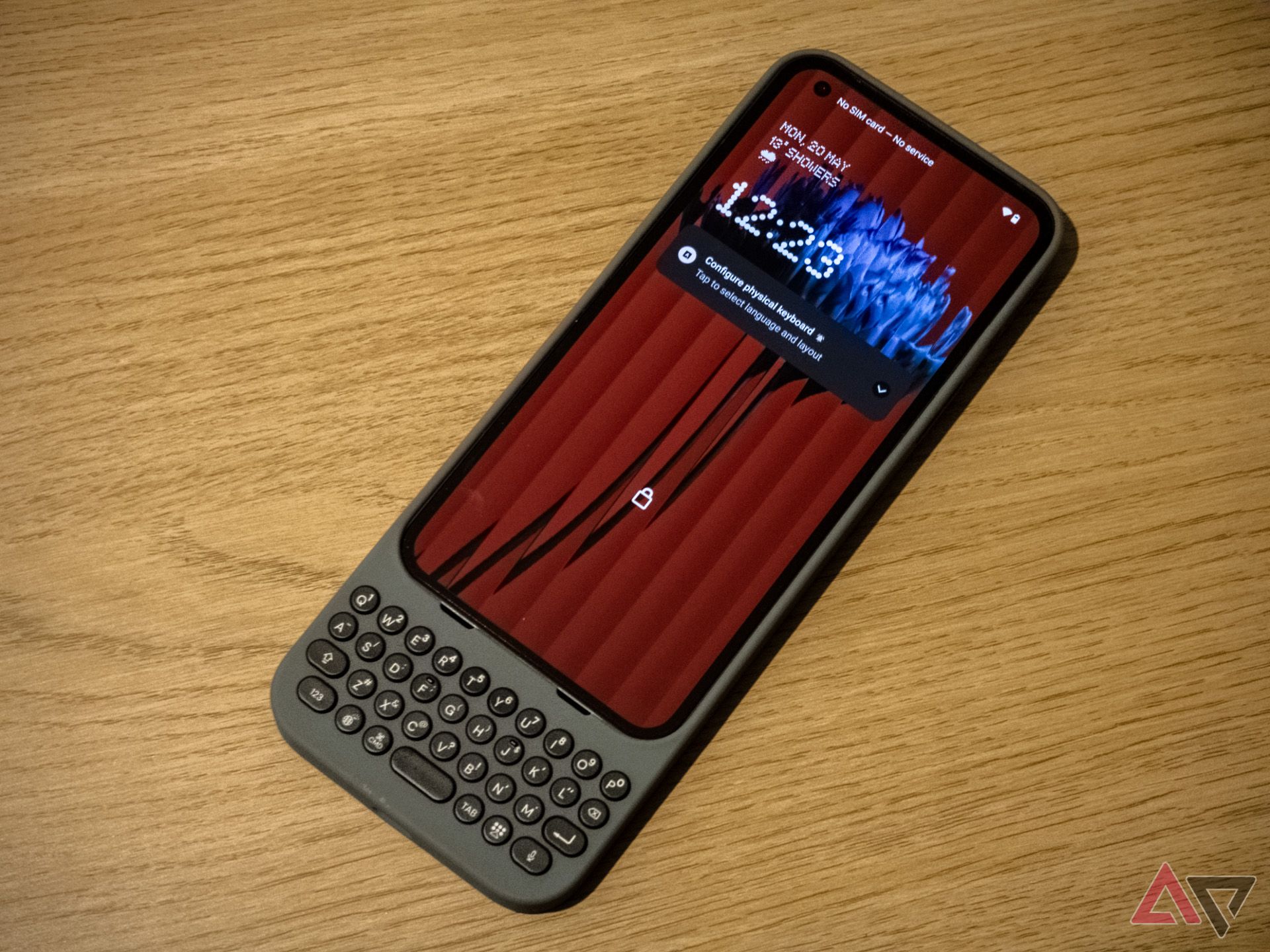 The Nothing Phone 1 sitting in a Clicks iPhone case with the lock screen shown.