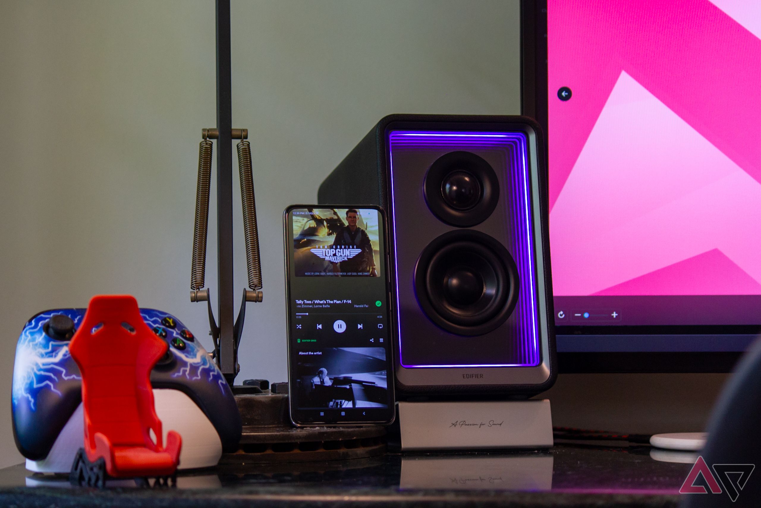 Edifier QR65 on a desk beside a phone playing Spotify